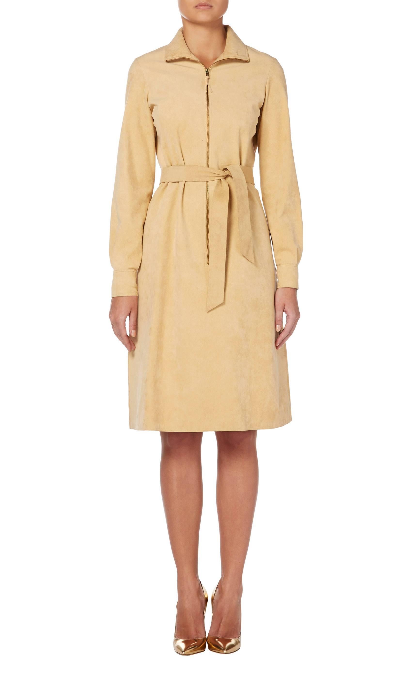 Constructed in Halston's signature Ultrasuede, this shirt dress, in a flattering neutral shade, is a fantastic work wear option. With a zip to the front, slip pockets on the hip and a fabric-matched belt at the waist, this dress is chic yet