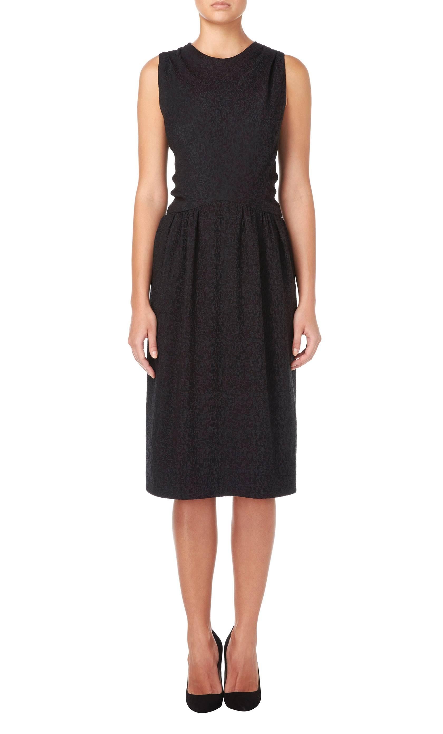 This incredibly chic little black dress is a true classic and will quickly become a wardrobe staple. Constructed in black cloqu̩ silk and featuring a cross over to the back, the dress skims the body to create a flattering silhouette. Fabric-matched
