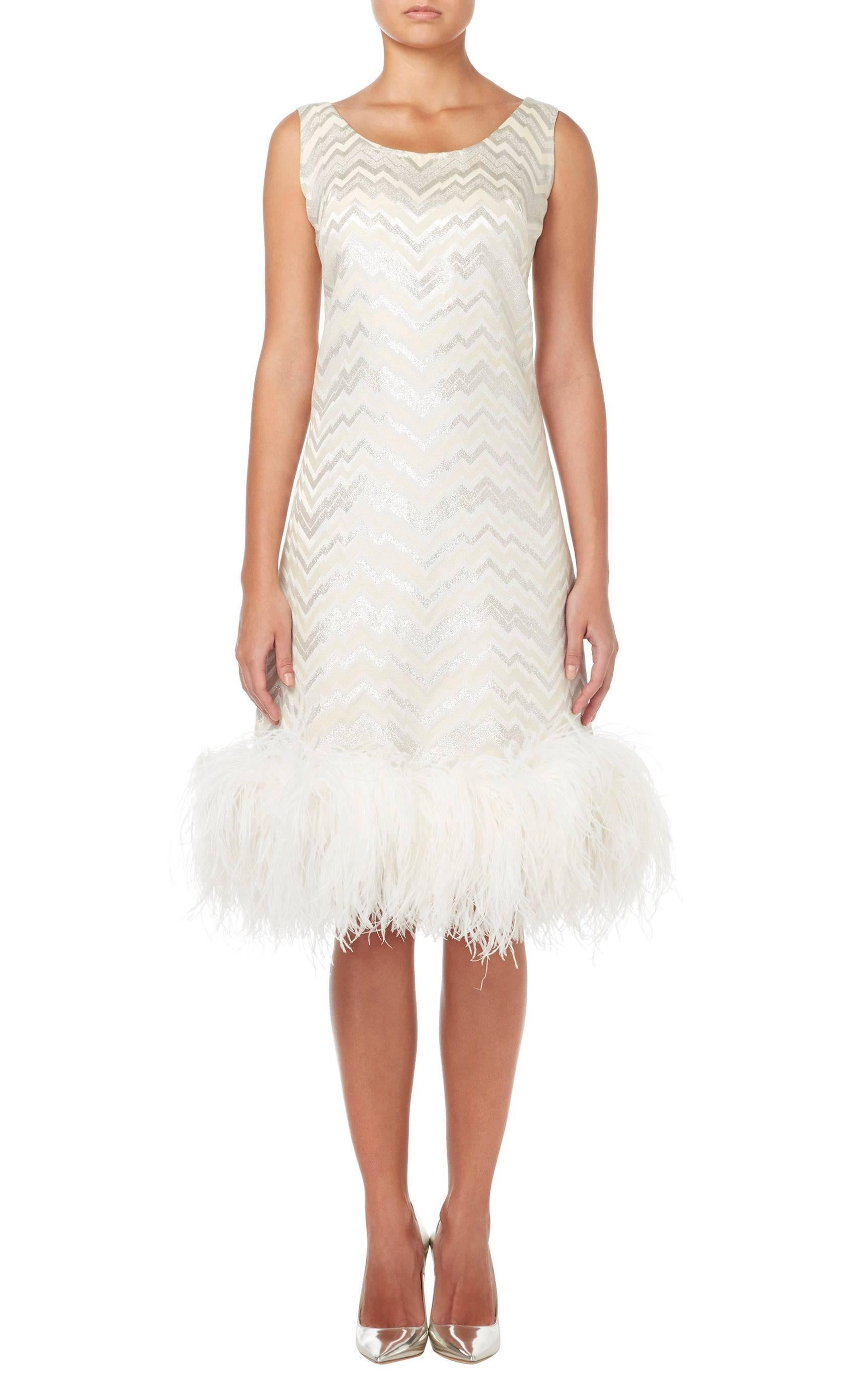Constructed in ivory silk with a silver Lurex zigzag pattern
Featuring an ivory marabou feather hemline
Zip fastening to the rear
Excellent condition with some small marks to the fabric and bears the original label, lining and