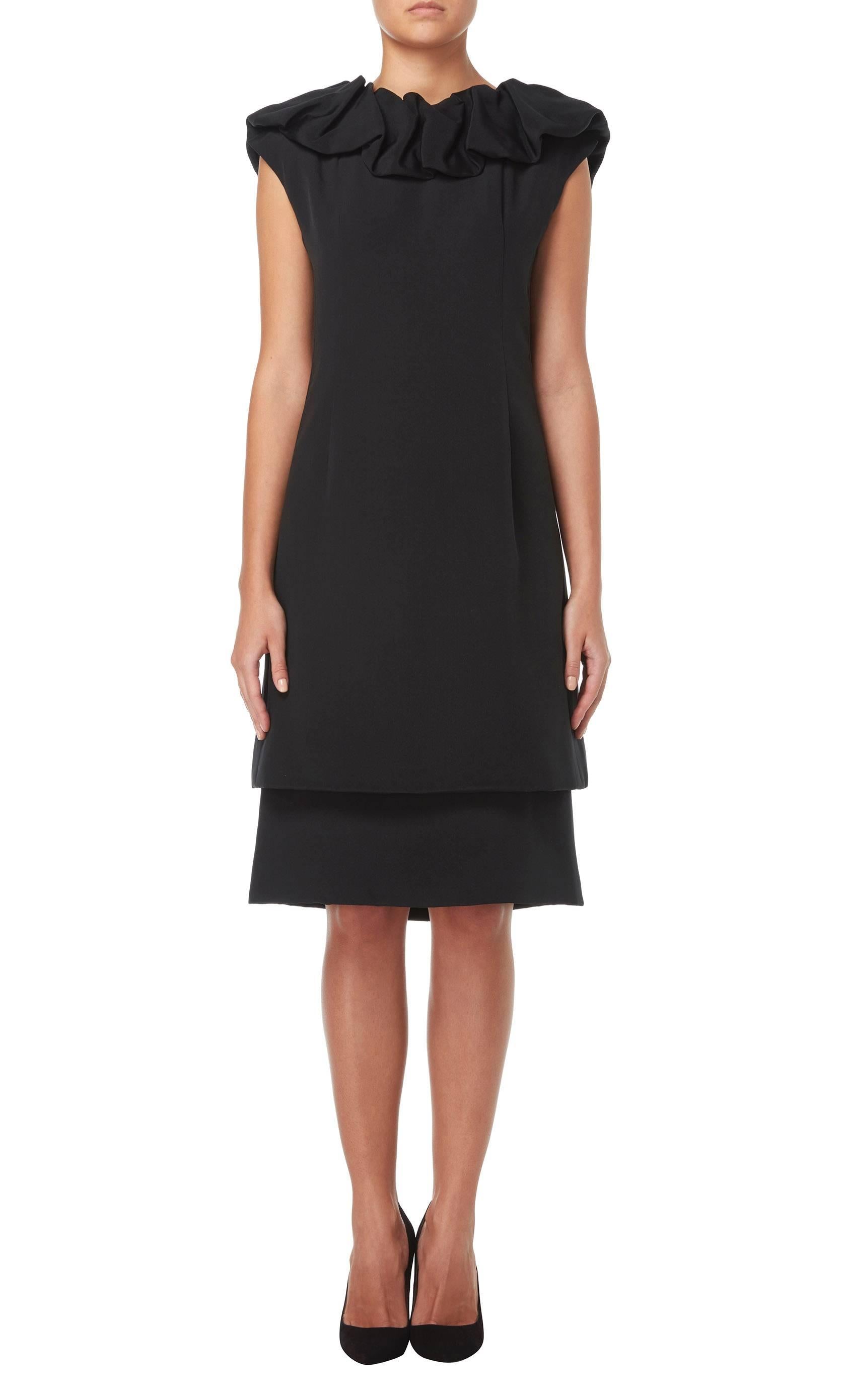 A twist on the classic LBD, this Dior dress is made up of a black silk under dress with a separate tunic over the top, creating a layered effect. The tunic features an exaggerated ruffle collar, adding drama, while the A-line cut makes for a classic
