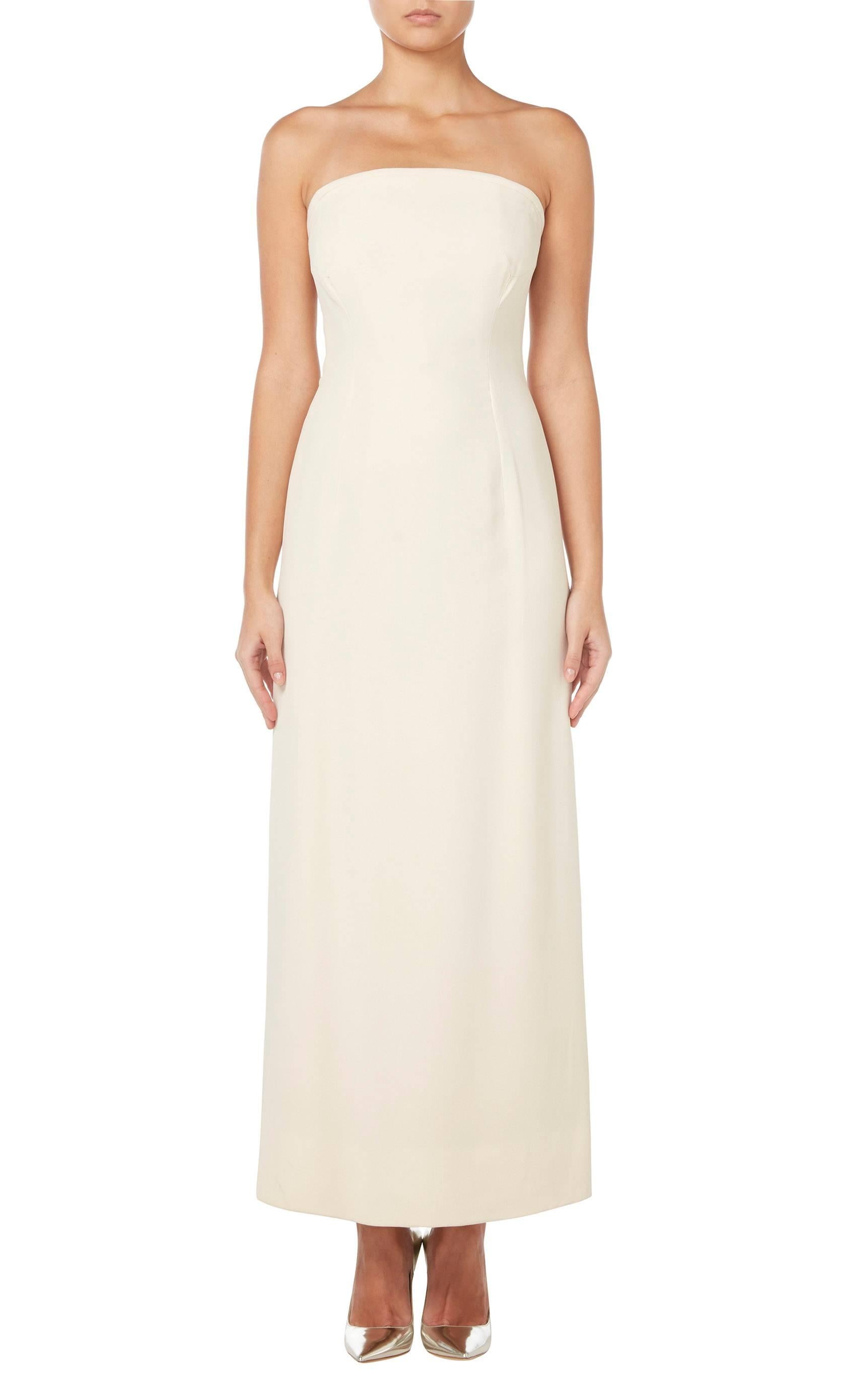 An incredibly chic and modern piece of haute couture, this Jacques Griffe strapless dress is constructed in ivory silk and features an internal boned corset. The column cut of the dress gives a clean silhouette, while a subtle tie detail to back