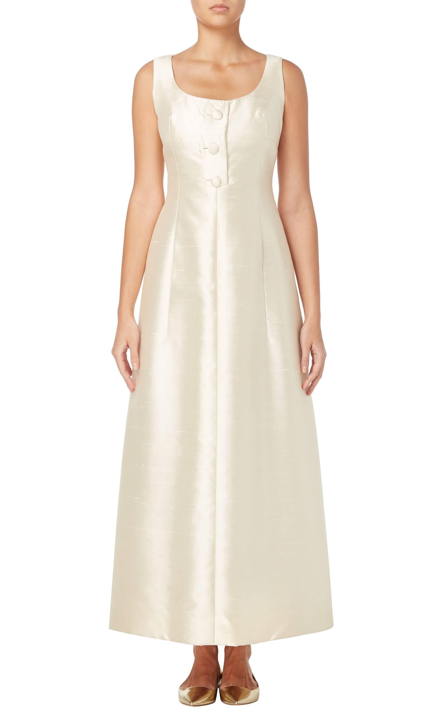 With beautiful Dior inspired form and detailing, this simple, classic dress would make a stunning choice for a wedding. Constructed in ivory silk, the dress has a flattering Princess cut and features button detailing to the front.

Constructed in