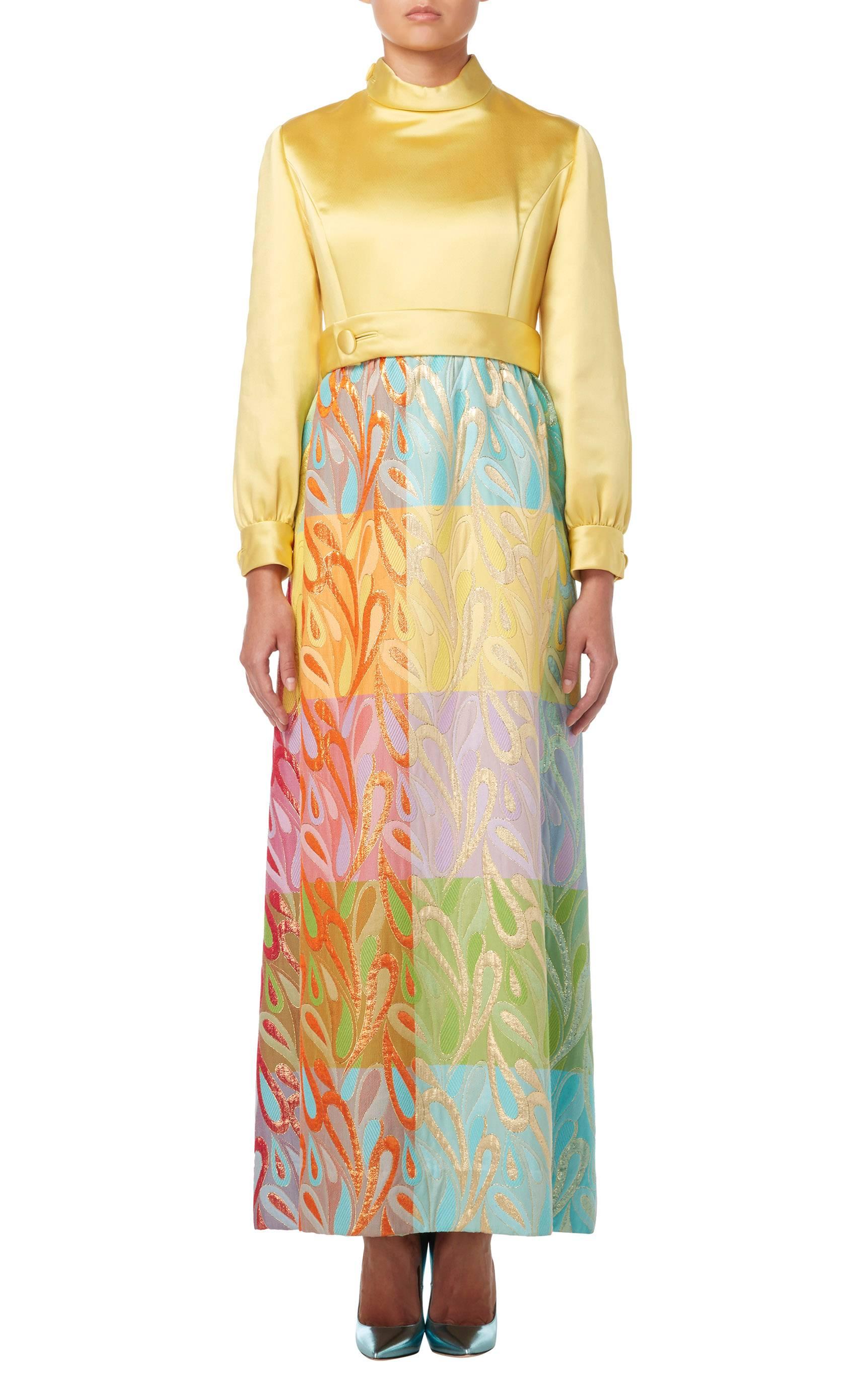 Featuring a sorbet yellow top constructed in luxuriously thick silk and a spectacular contrasting silk lurex full skirt in a warm and acidic colour-way, this Malcolm Starr dress artfully crafts hot colours in a winter weight. Detailing fabric