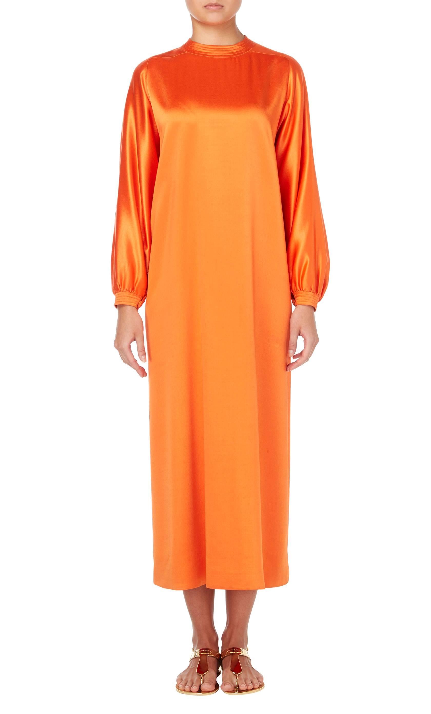 This Givenchy kaftan, constructed in a vibrant shade of orange silk, is a great choice for summer parties and events. The round neckline and cuffs feature a ribbed detail, while a cut-out to the rear of the neck fastens with a single button. The