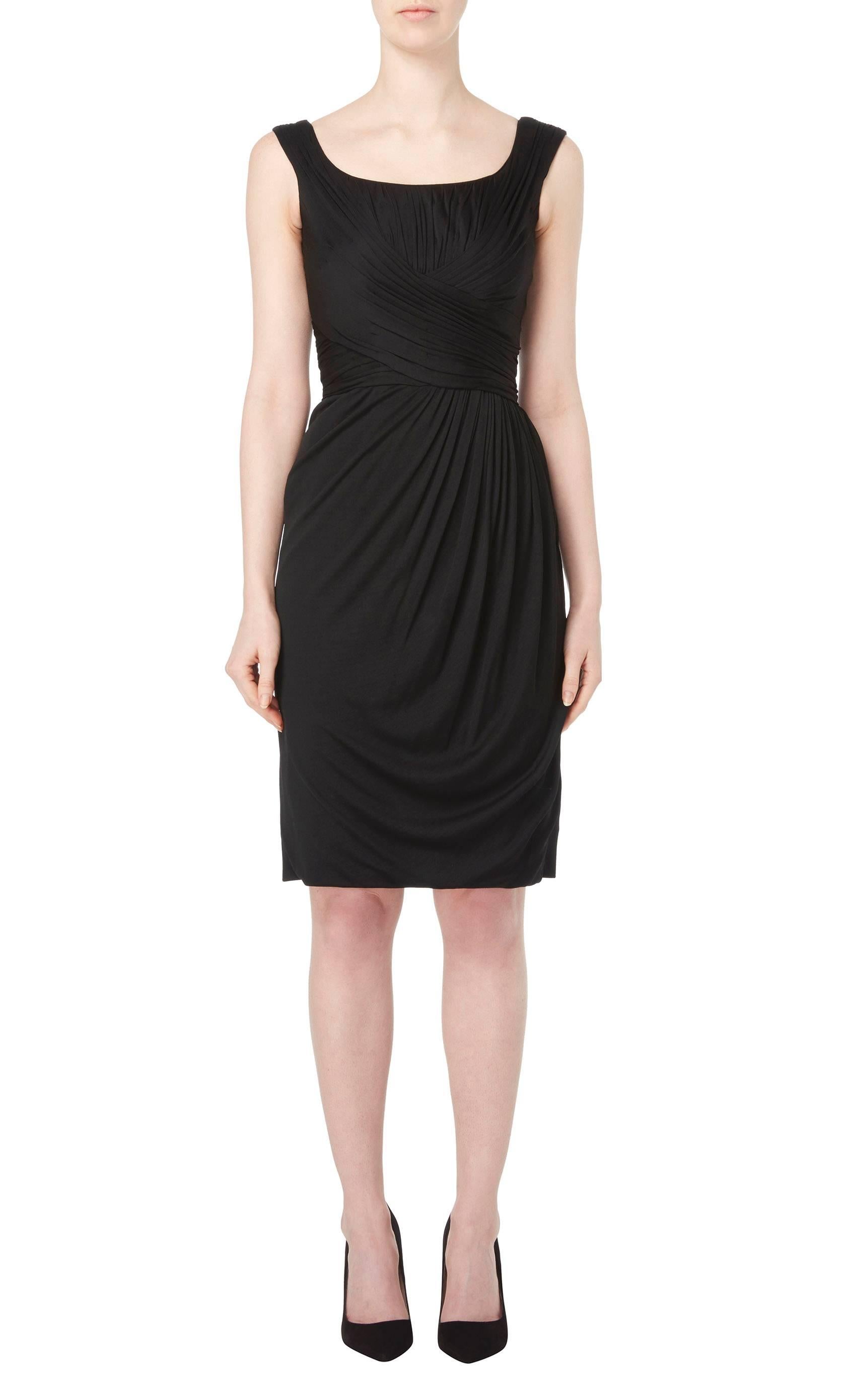 This chic LBD is truly timeless and the perfect way of introducing vintage into a modern wardrobe. The pleating detail crosses over on the bodice, accentuating the waist, and the silk jersey drapes softly into the front of the skirt. The flattering