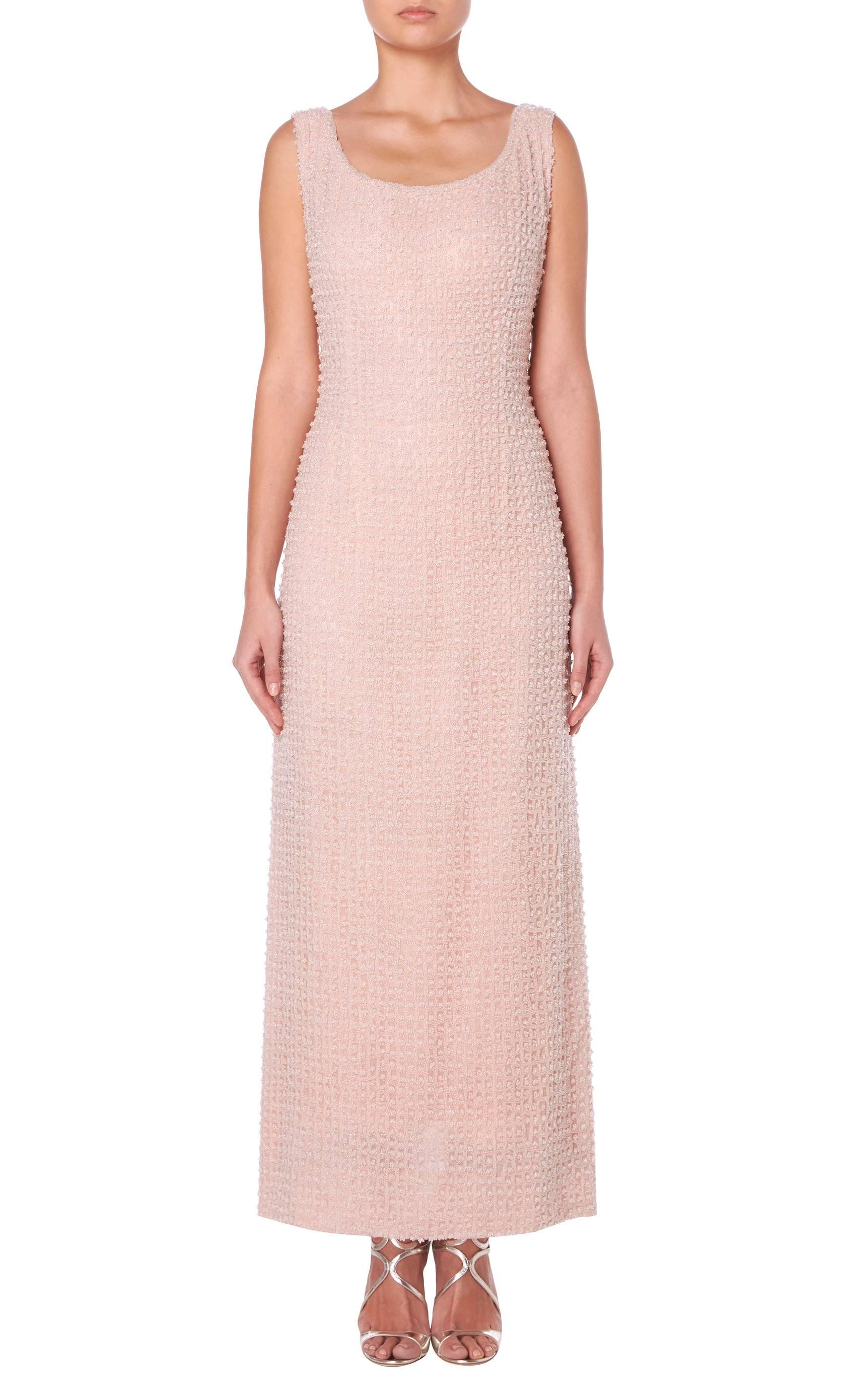 This stunning Guy Laroche haute couture gown is constructed in pale pink lattice-style beading, giving a hint of shimmer when it catches the light. Featuring a flattering scooped neckline to the front and back, the gown skims the body to highlight