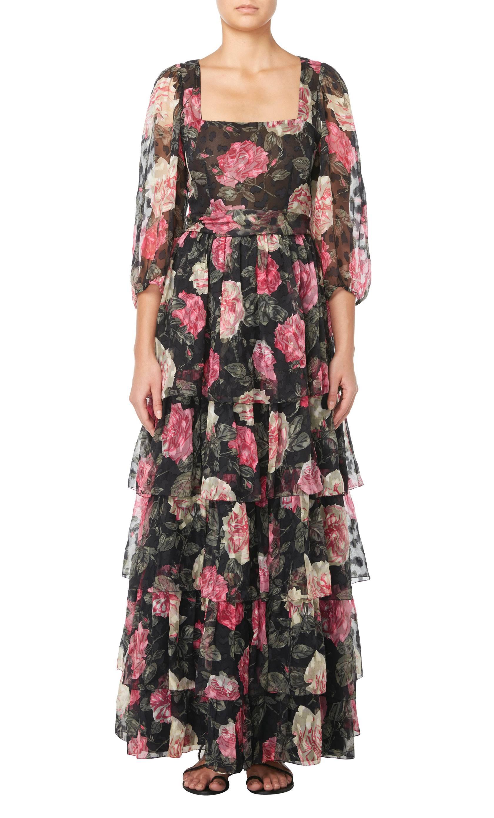 This beautiful Thea Porter couture floral dress is incredibly feminine and would make the ideal choice for a summer garden party. Constructed in black chiffon and featuring a pink, ivory and green floral print, the dress features a flattering square