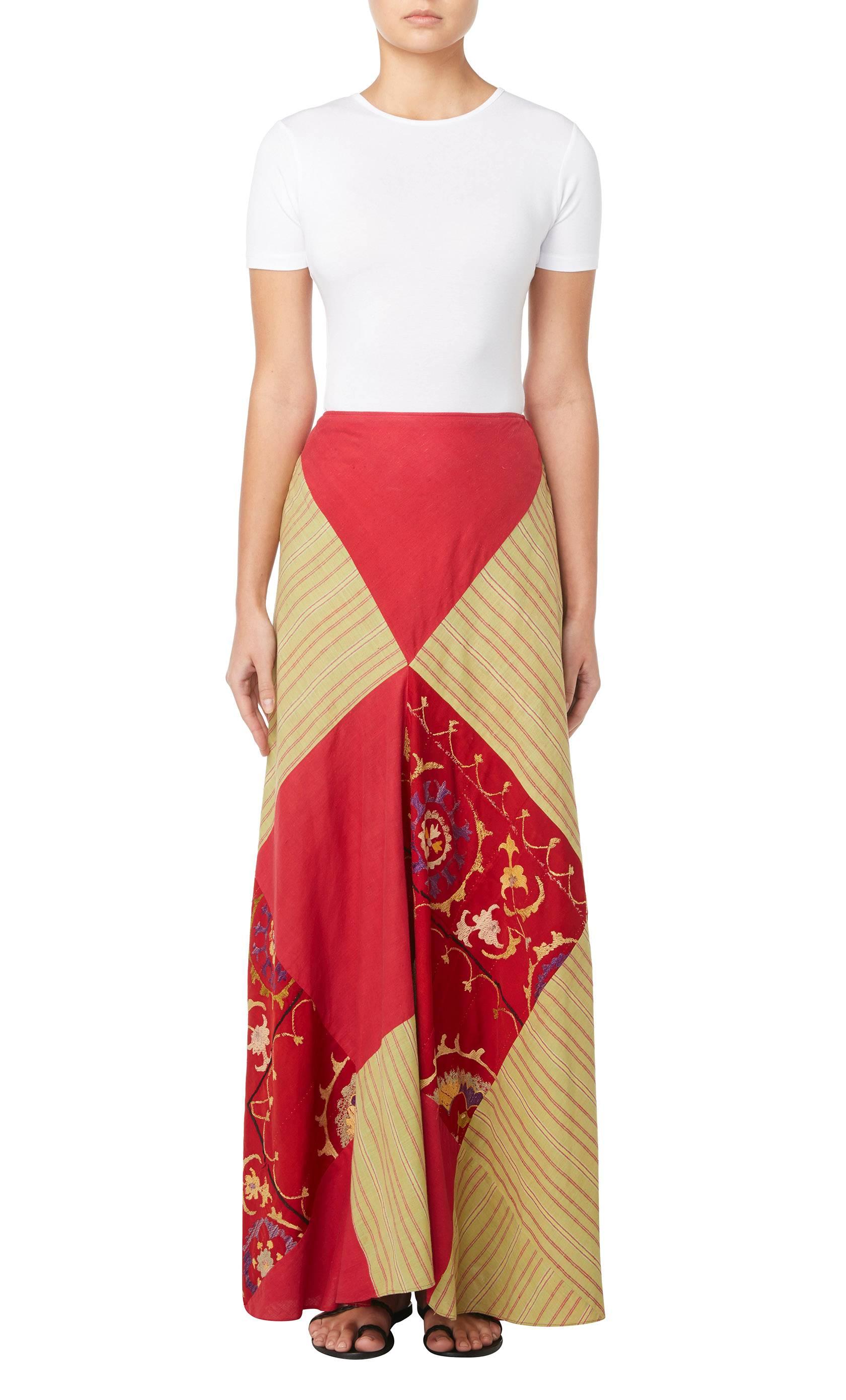
This patchwork maxi skirt is an excellent example of Thea Porter's bohemian designs, inspired by her travels across the world. This couture skirt is constructed in diamonds patches of green striped madras and red cotton, and featuring intricate