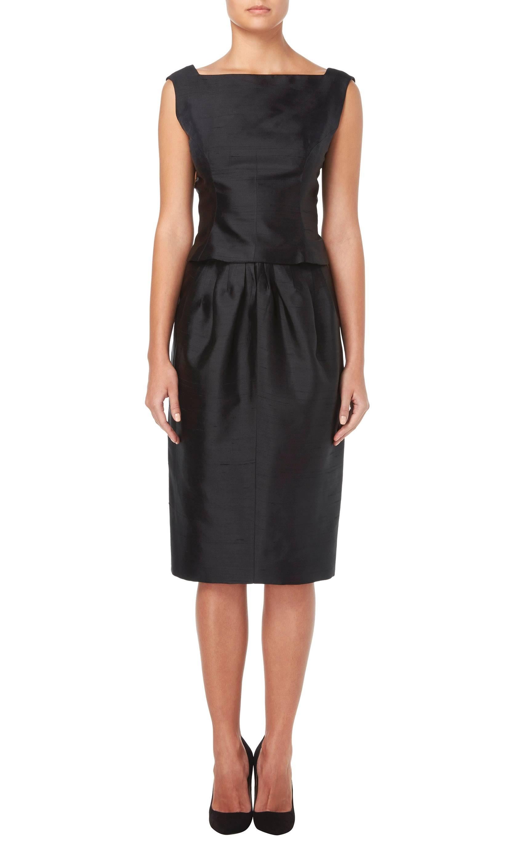 This timeless Jean Patou haute couture LBD is a fantastic investment piece. Constructed in black silk and giving the illusion of a separate top and skirt, the dress fastens to the back with a concealed zip and fabric-matched buttons.

Constructed