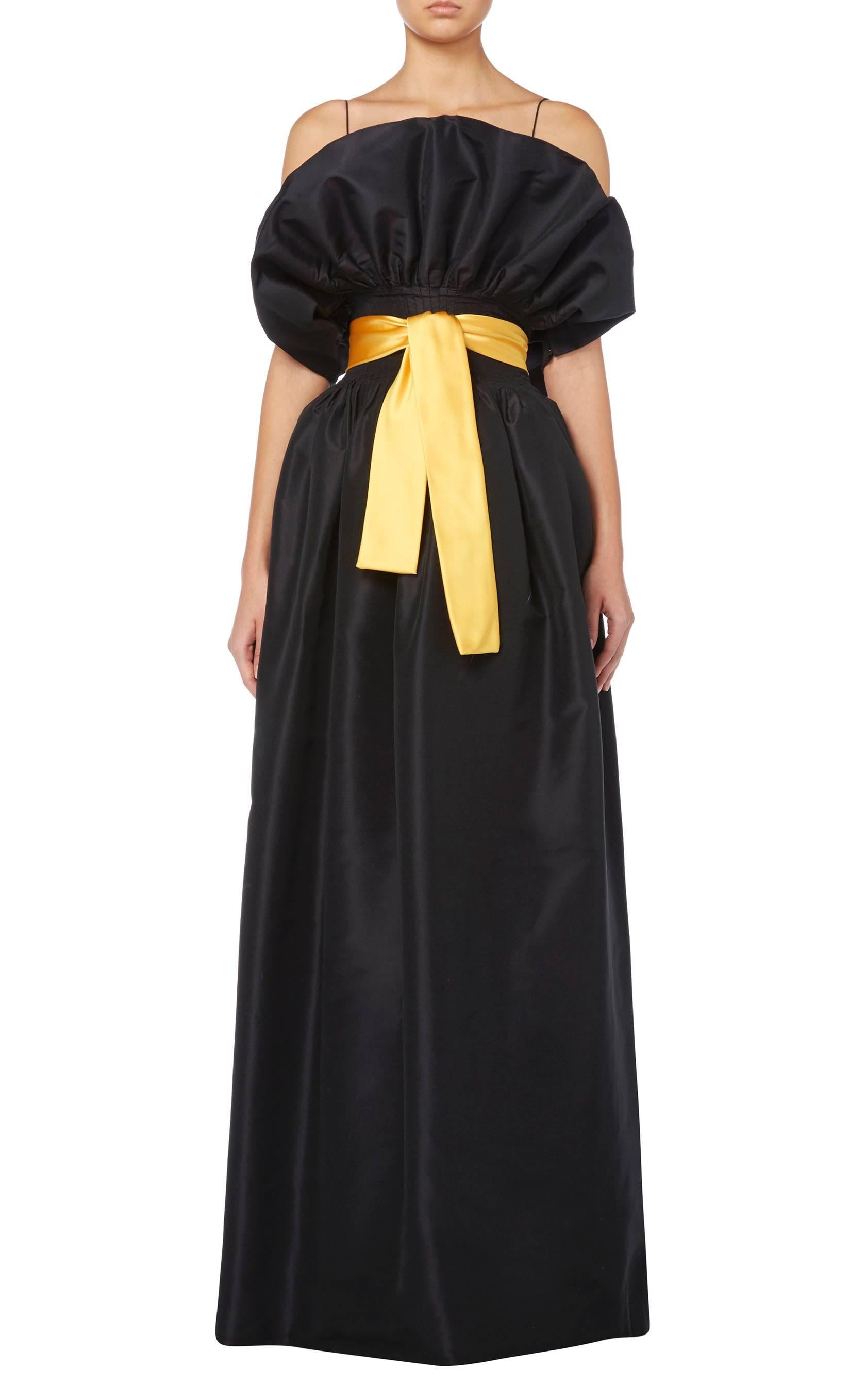 A wondrous piece of haute couture by Pierre Cardin, this dress is formed of two parts. The spaghetti strap top, hand-embroidered with black sequins, leading into the separate voluminous black silk taffeta skirt and is finished with a canary yellow