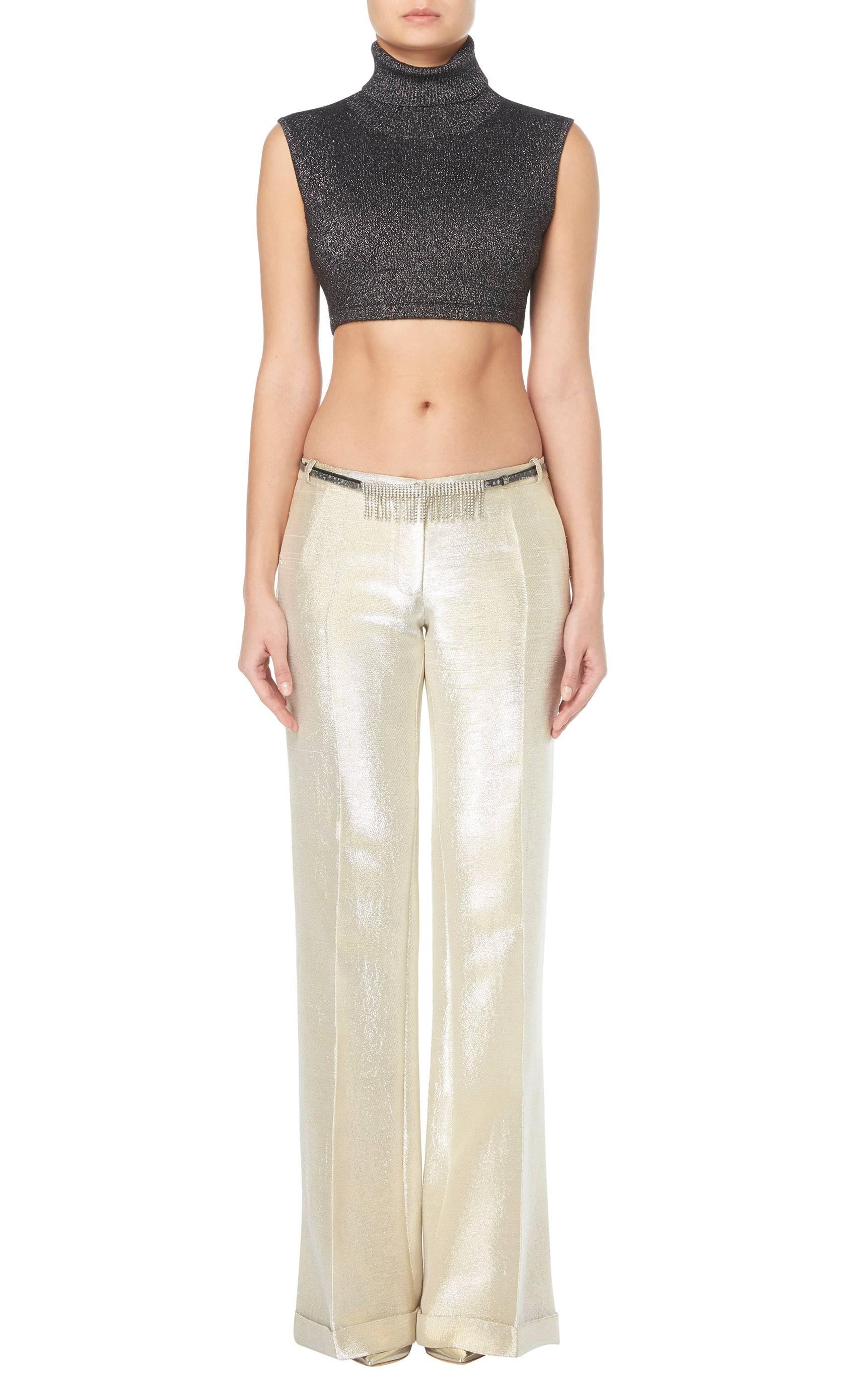 Work a little 90s into the wardrobe with this Balmain two piece. This fabulous ensemble is made up of a cropped sweater vest in black and silver Lurex with, flared metallic lurex trousers and a crystal studded belt.

Constructed in metallic silver