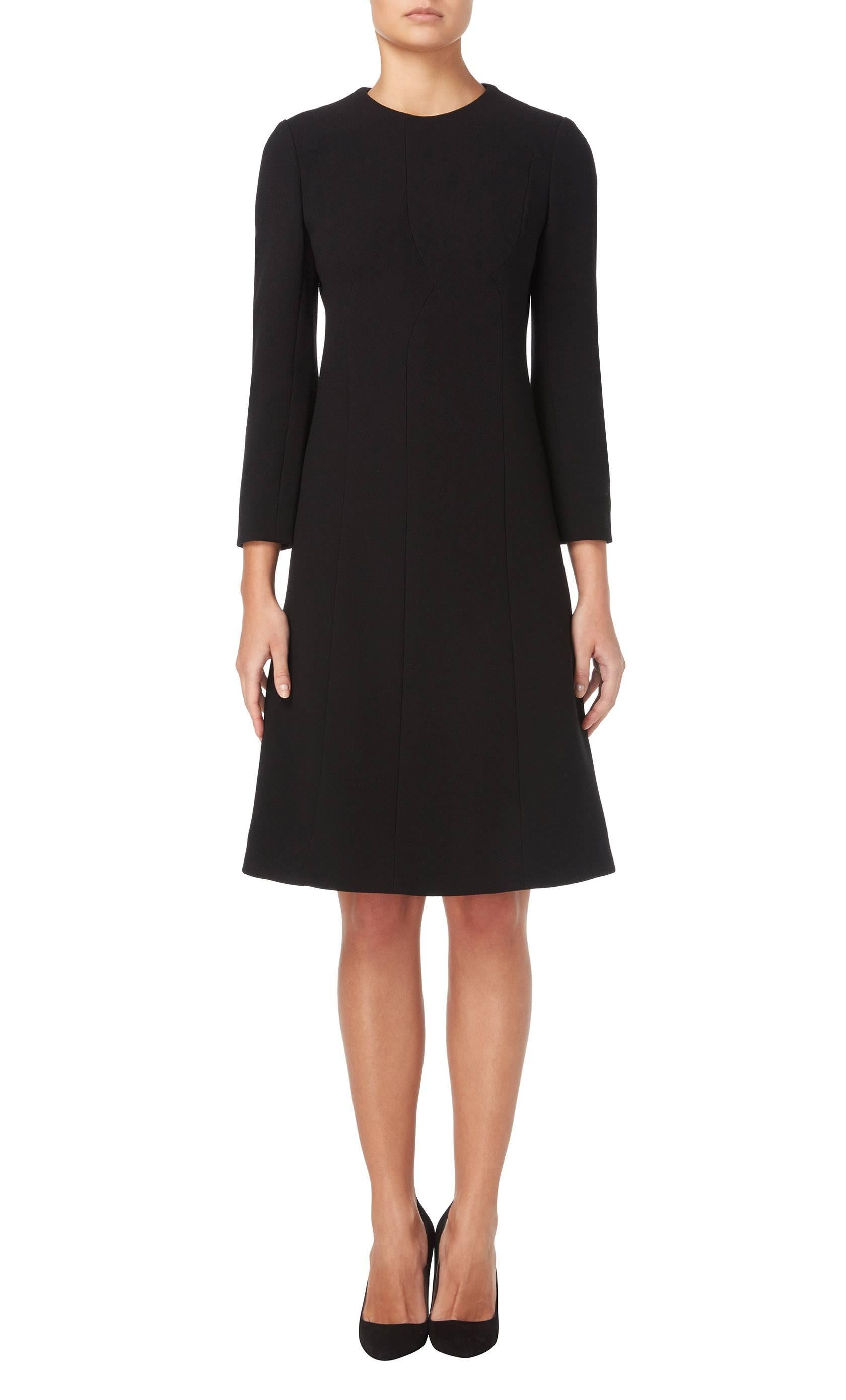 An incredibly chic LBD, this Galanos dress is a timeless piece that will go from day to night with ease. With a high neck and long sleeves, and bracelet length sleeves, the dress features curved seam detailing to the front, enhancing the