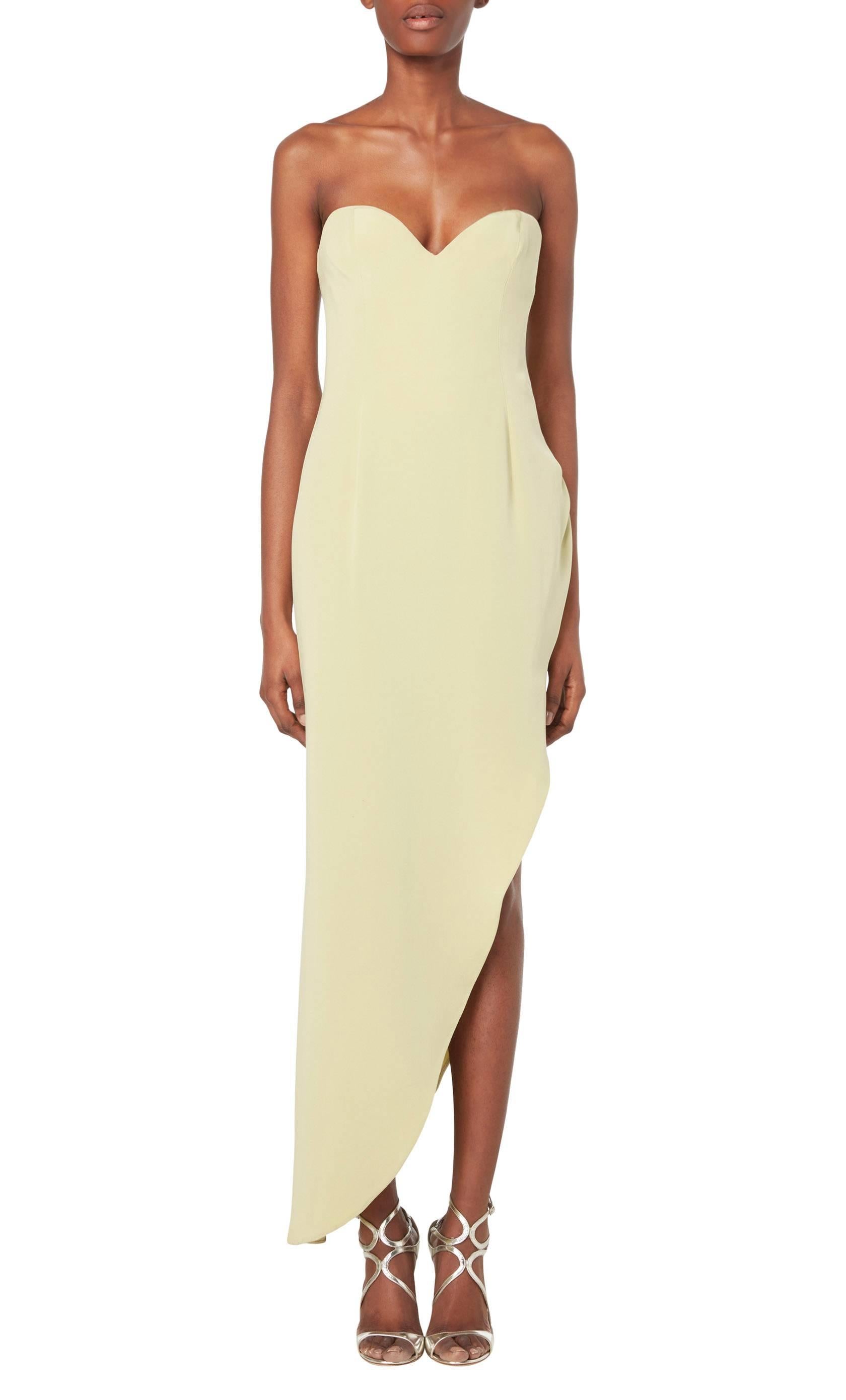 Constructed in pale green silk, this Fiandaca evening dress is incredibly sexy! Strapless, with a sweetheart neckline, the fabric skims the body seductively, falling into an asymmetric cut at the hem. Finish the look with a pair of killer heels and