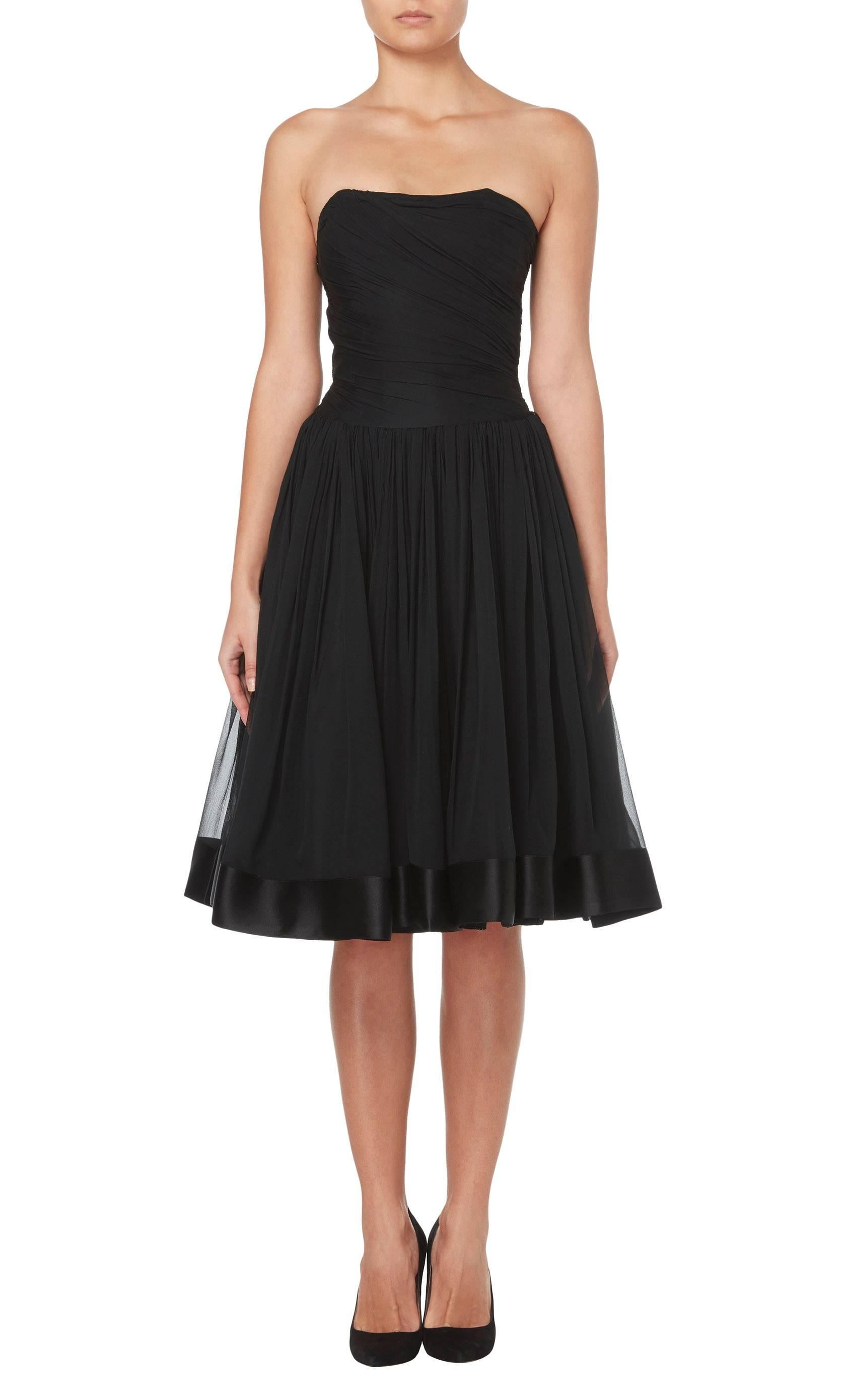 The ultimate LBD, this stunning Guy Laroche haute couture cocktail dress is the height of chic! Constructed in black silk chiffon, the strapless dress has a boned bodice and a sweetheart neckline, while the chiffon is ruched asymmetrically drawing