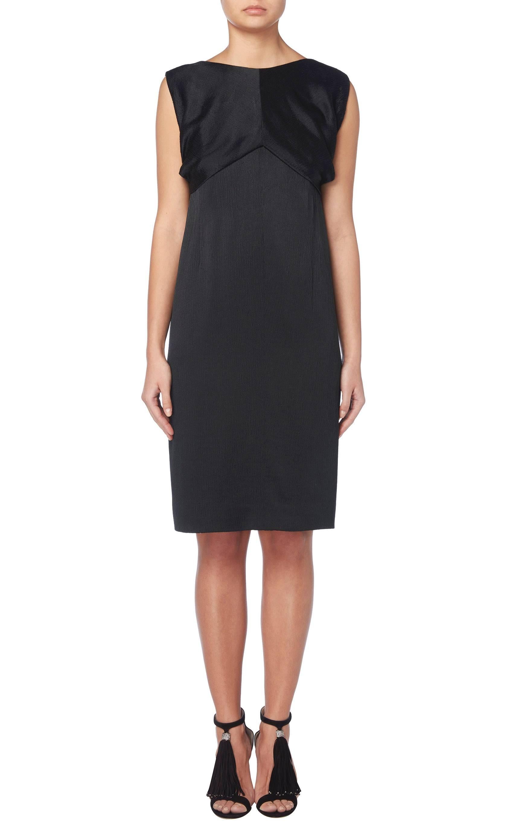 This stunning and chic haute couture dress by Balenciaga himself, is constructed in fine black matelassé silk. Featuring the original boned internal corset and silk liner this is an exquisitely constructed dress, prefect for dinners, cocktails and