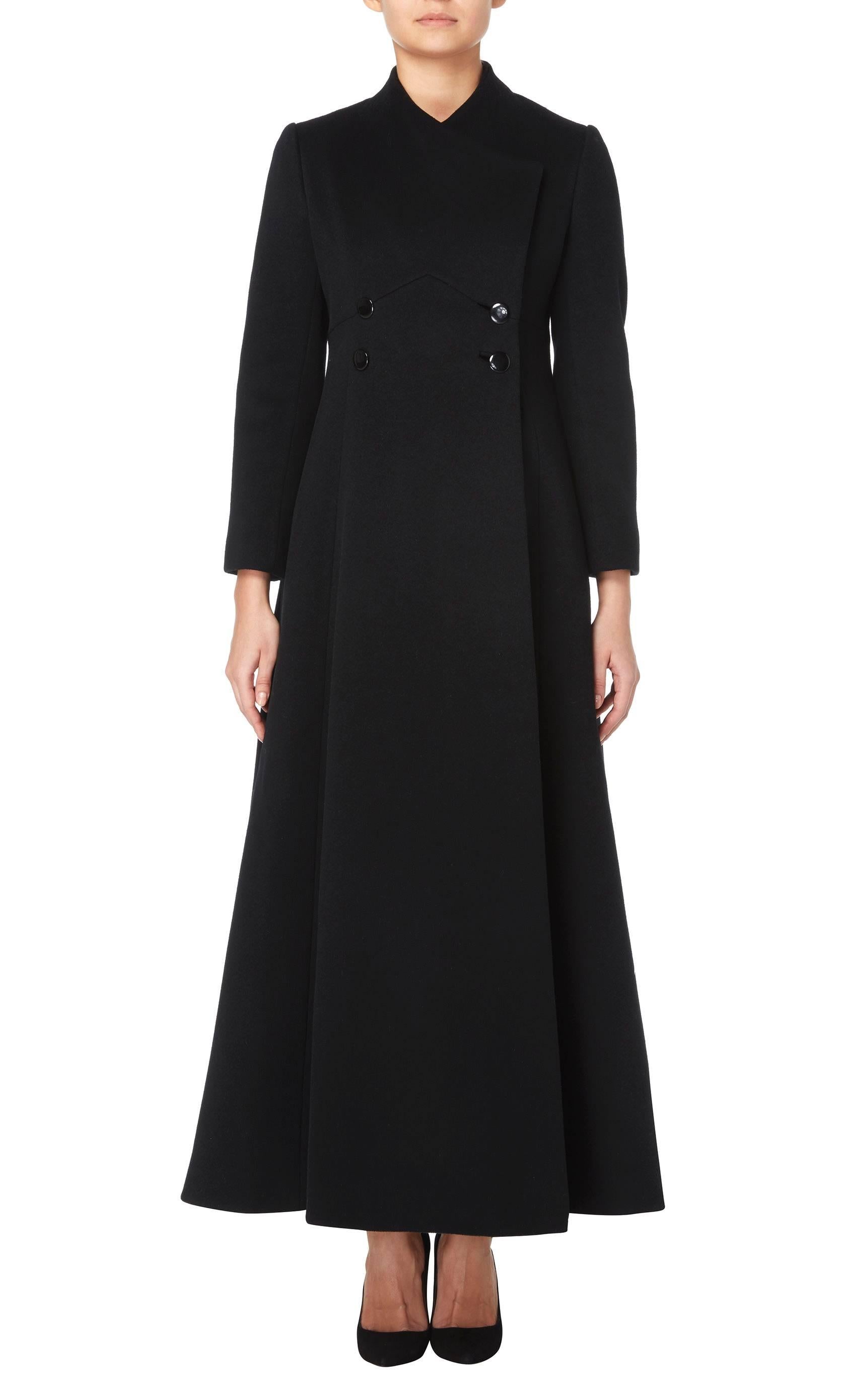A chic and dramatic floor-length coat in black wool, with double-breasted detail and a distinct A-line shape. Perfect for day, night or anything in between.

Constructed in black wool
Double-breasted with hidden pockets on the hip
Buttons