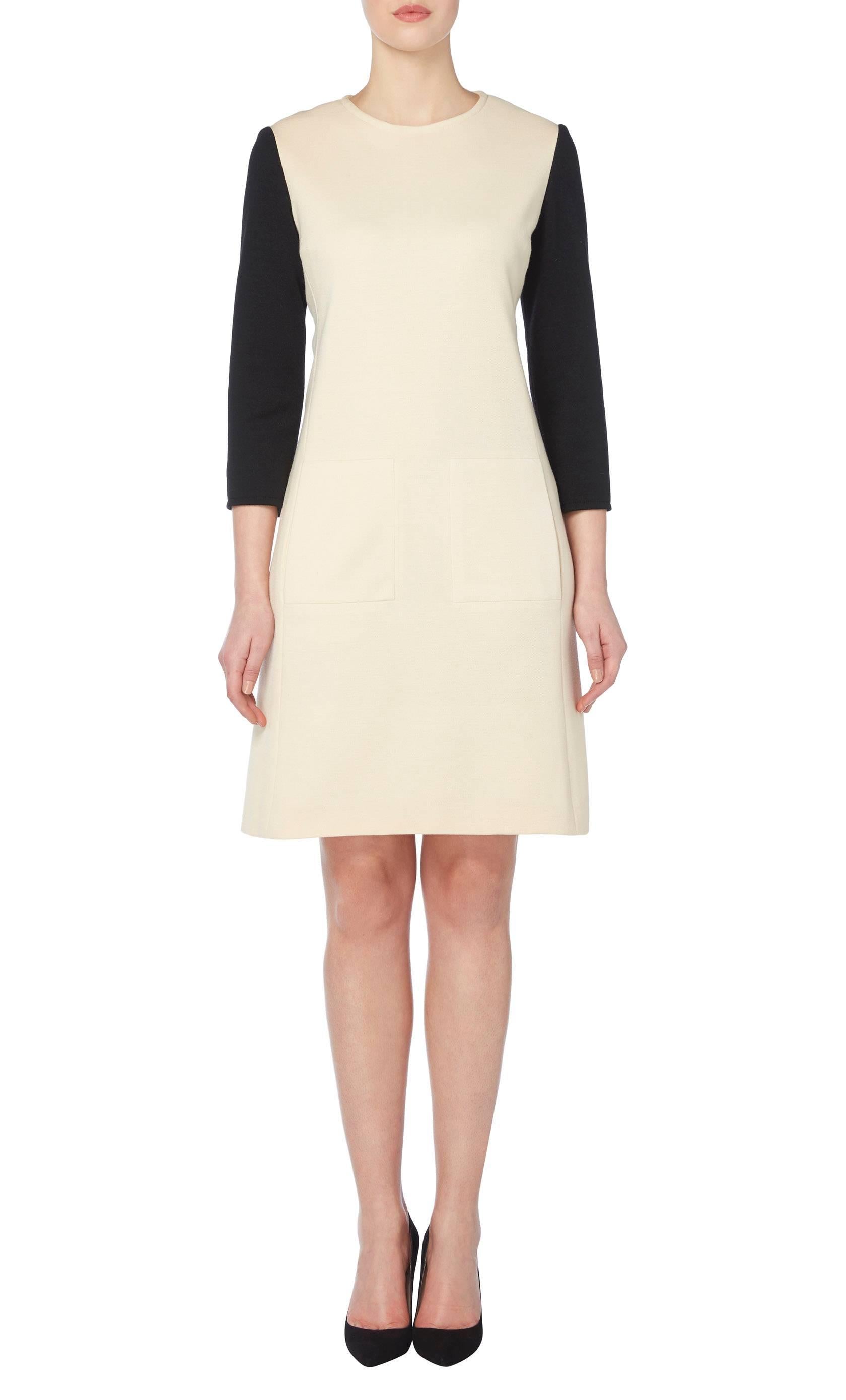 This Givenchy shift dress is incredibly chic and the classic 60s silhouette and clean lines make it ideal for the office. Constructed in ivory wool and featuring contrasting black sleeves, the dress has a round neckline and overscale pockets to the