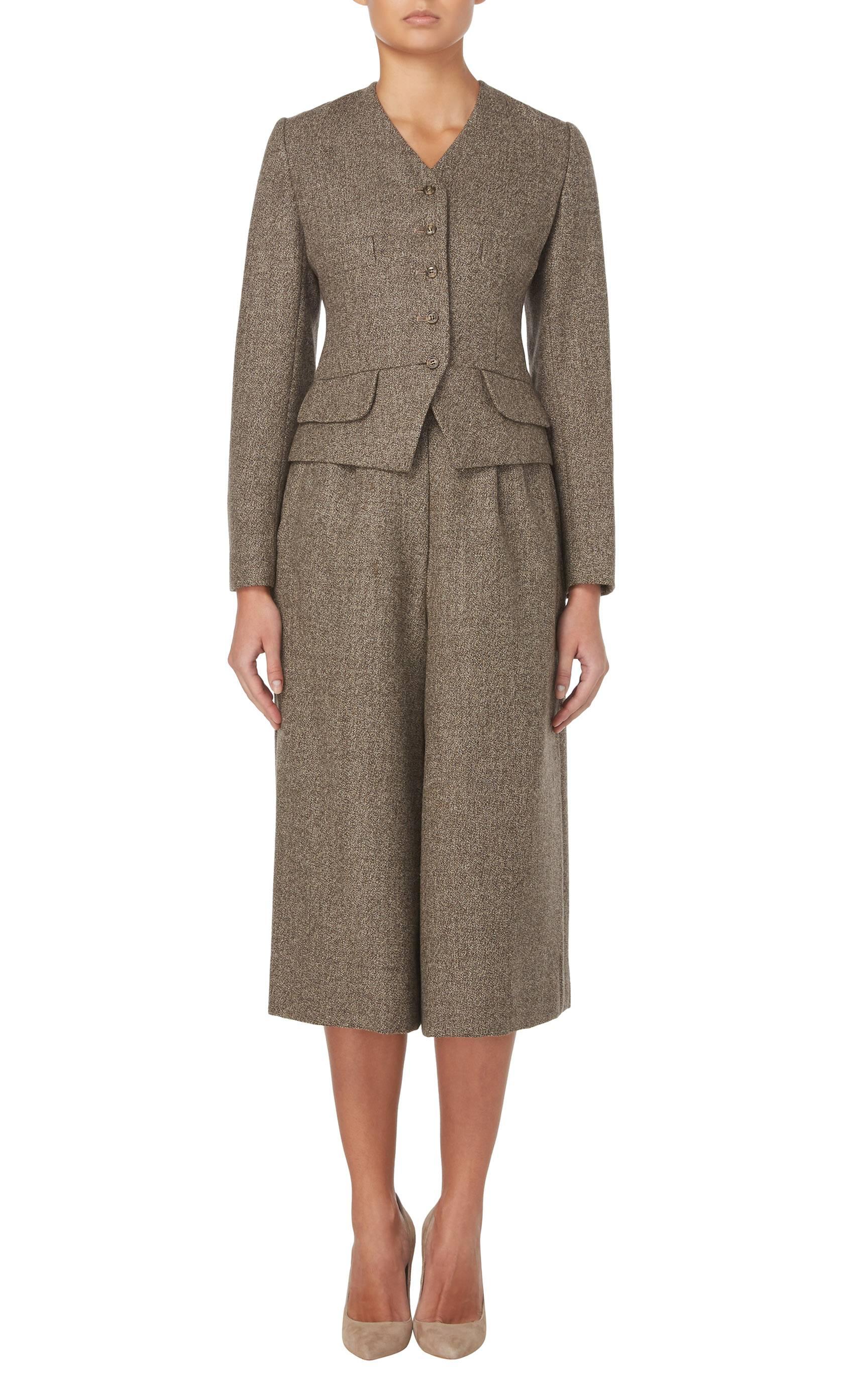 This three-piece ensemble is a superb example of Bill Blass tailoring, composed of mid-length culottes, fitted sleeveless top and a box cut jacket in brown wool. The 1970s had a revival of 1920s style thanks to the first film version of 'The Great