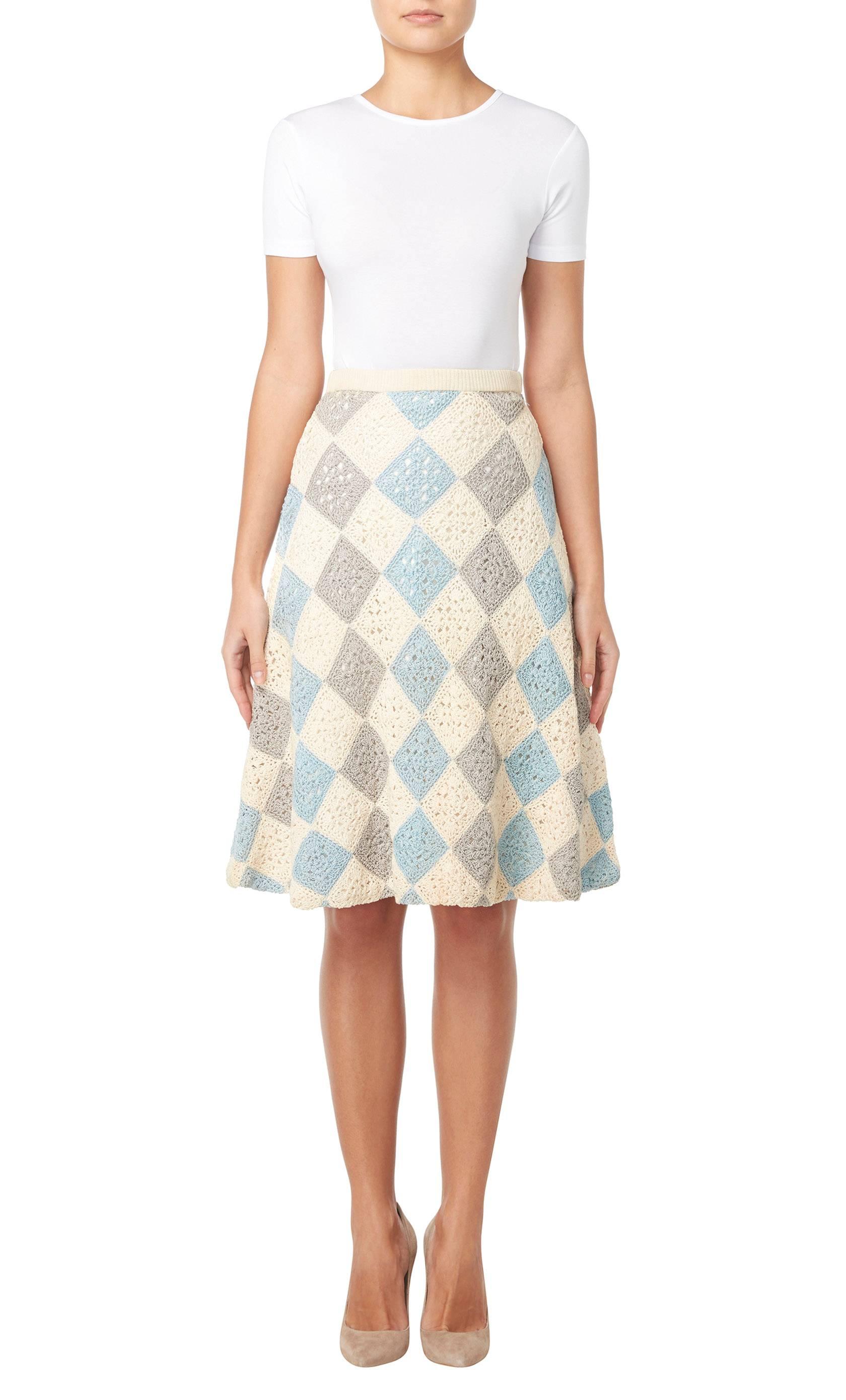 This Jean Dessès skirt is such a fun piece and great for the summer. Made up of crochet diamonds in blue, cream and grey wool, the skirt is fully lined in cotton, which adds structure to the A-line silhouette. Wear with a silk camisole and strappy