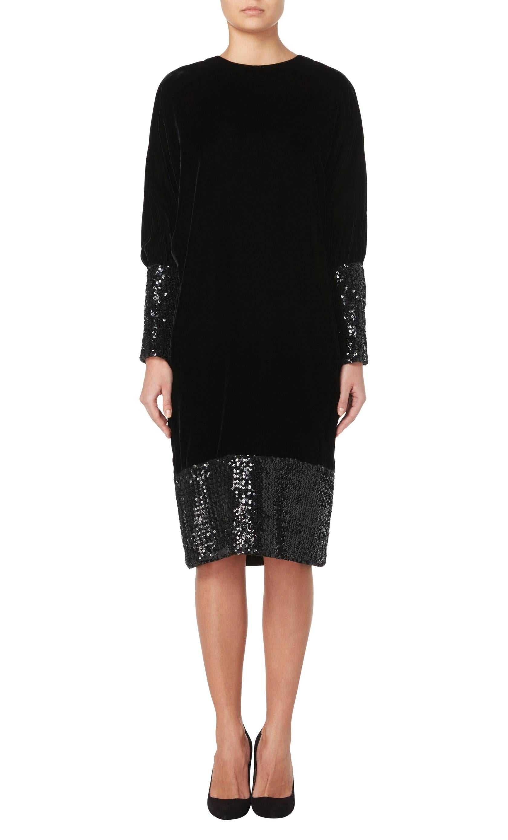 A luxurious and thoroughly modern dress by the master of modernism, this is an LBD with attitude. Constructed in plush black velvet and edged with thousands of gunmetal sequins at both hem and cuffs, the dress is cut in a slouchy sweater style, with