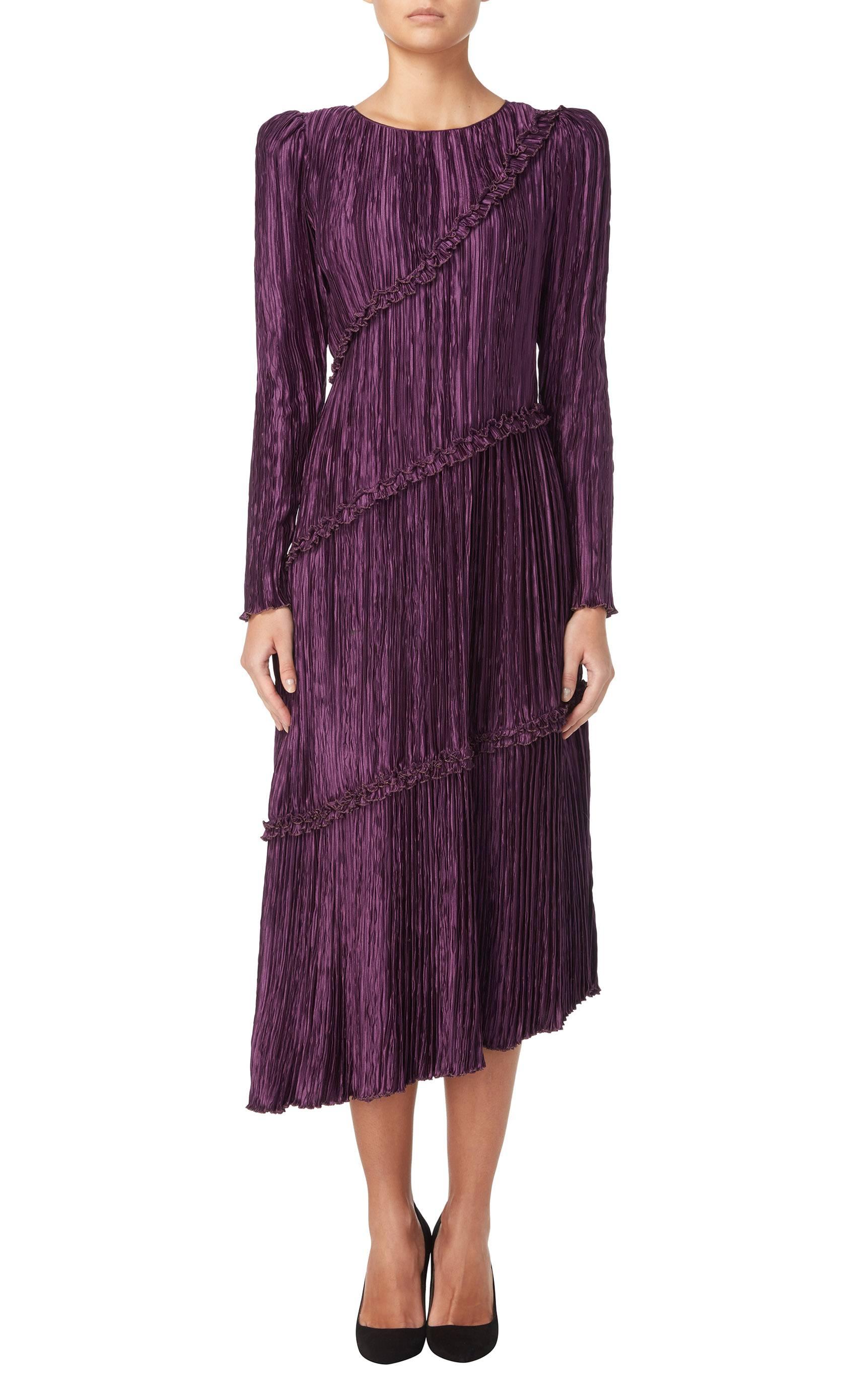 A fantastic example of the Marii pleating that Mary McFadden trademarked, this dress references those of Fortuny. Constructed in an amethyst purple reyon, the dress has an asymmetric hemline and ruffle detail.

Constructed in amethyst purple Marii