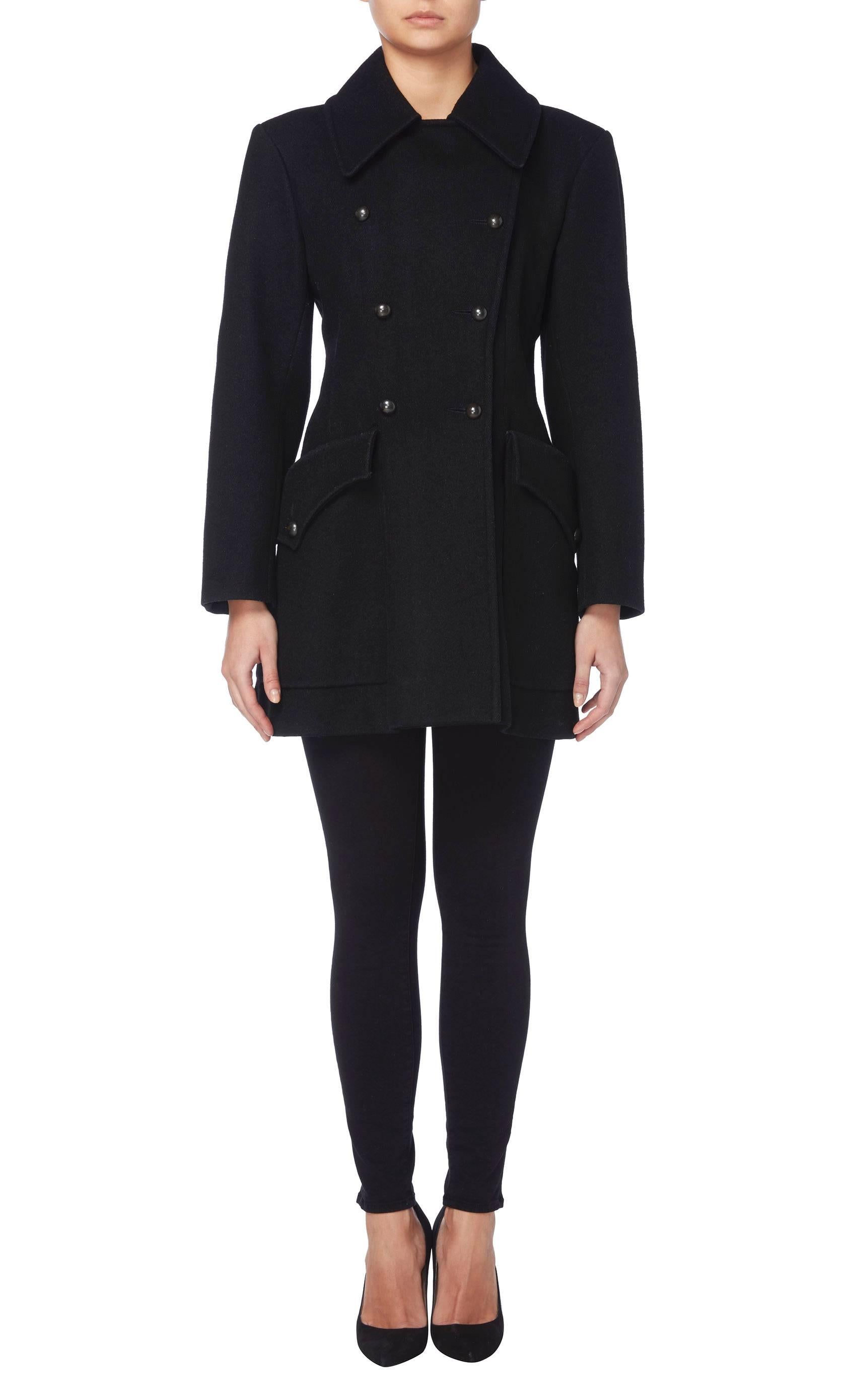 This classic Yves Saint Laurent peacoat is truly timeless and will quickly become a wardrobe staple. Constructed in black wool, the double-breasted coat features a double lapel collar and overscale pockets on the hip. Black buttons fasten to the