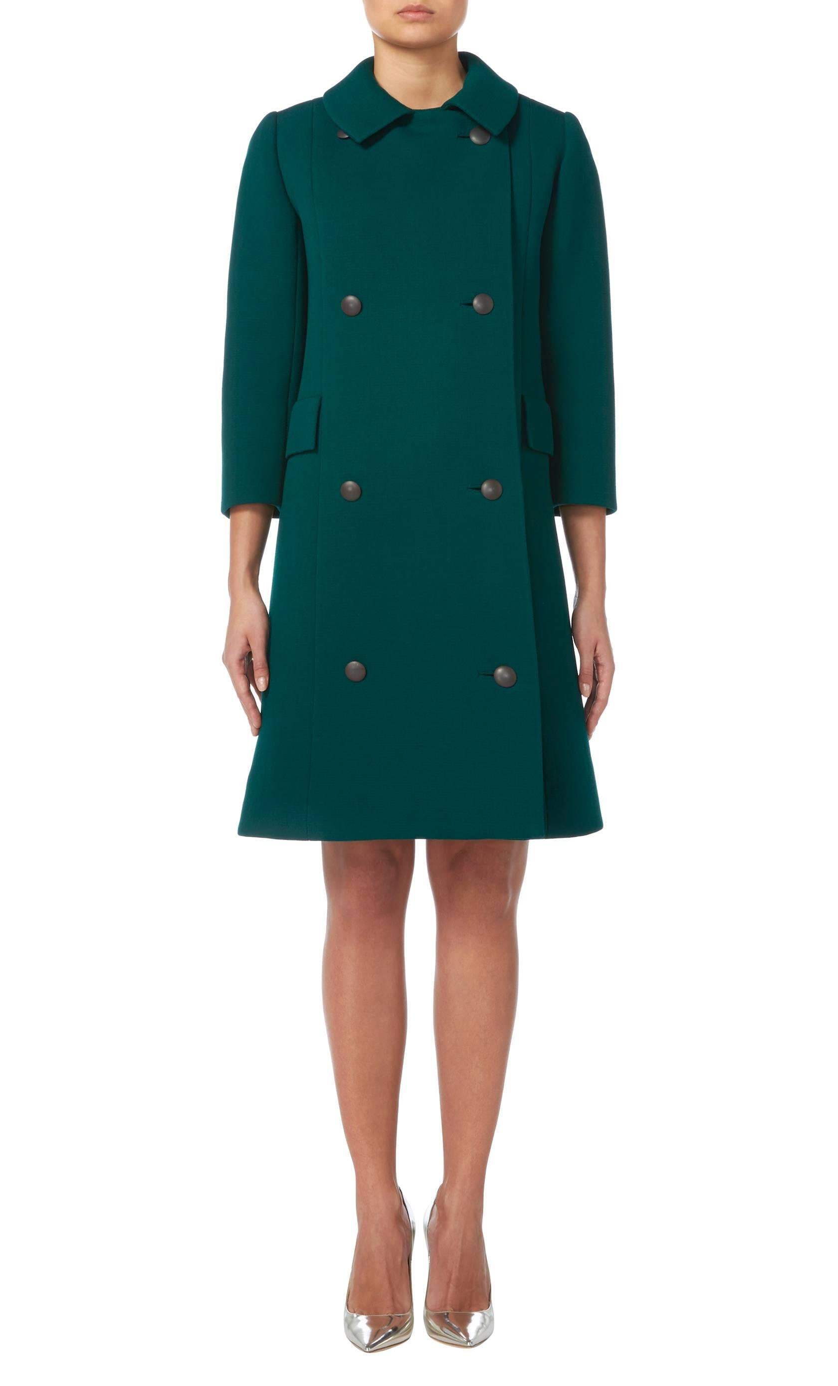 Comprising of a sleeveless dress and double-breasted coat
Constructed in green wool
Zip fastening to the rear to the dress and buttons to the front of the coat
Excellent condition with the original label, belt, linings and