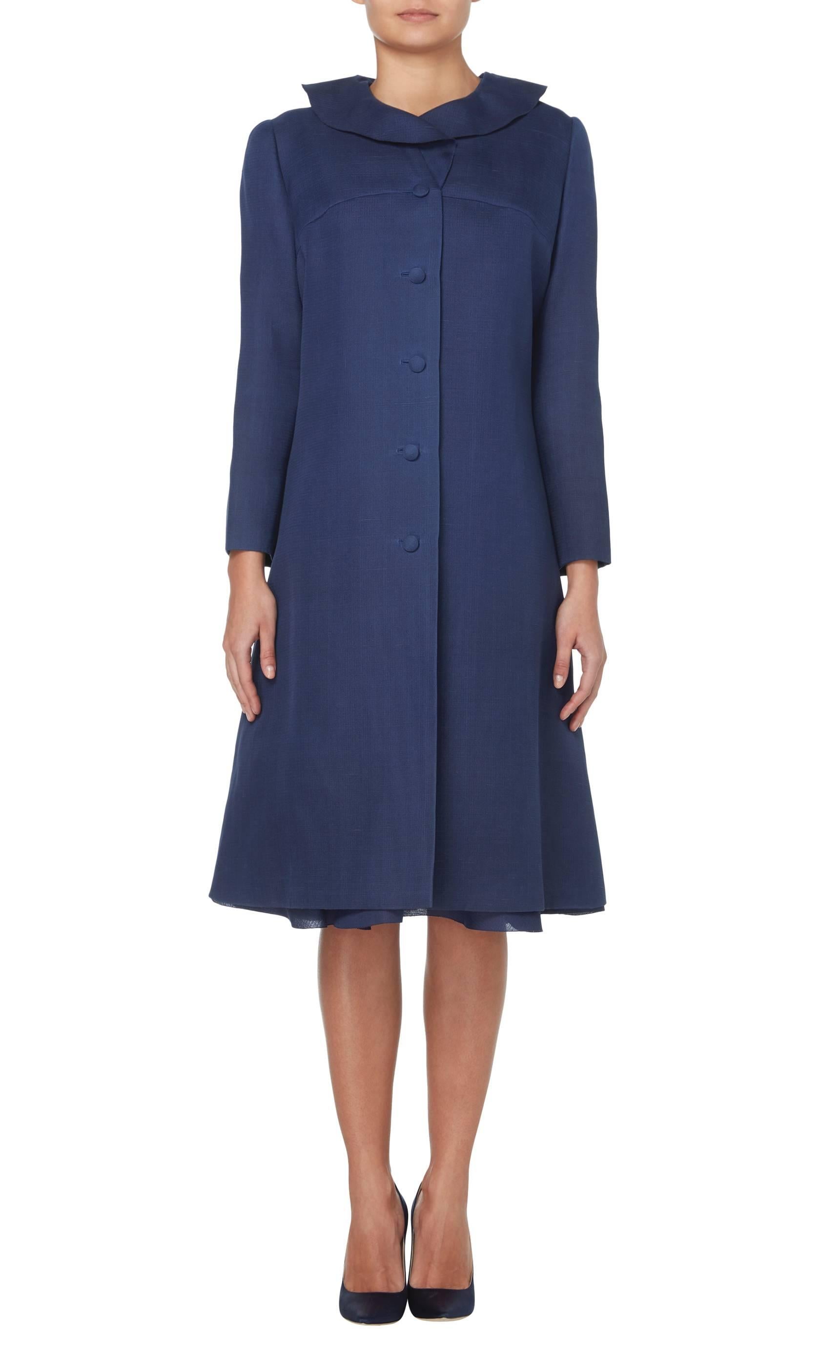 
The perfect piece for the races or summer parties, this Marc Bohan for Dior dress and coat ensemble is a fantastic piece of summer tailoring. Constructed in navy blue gazaar, the short sleeved dress features a feminine fluted skirt, while the coat