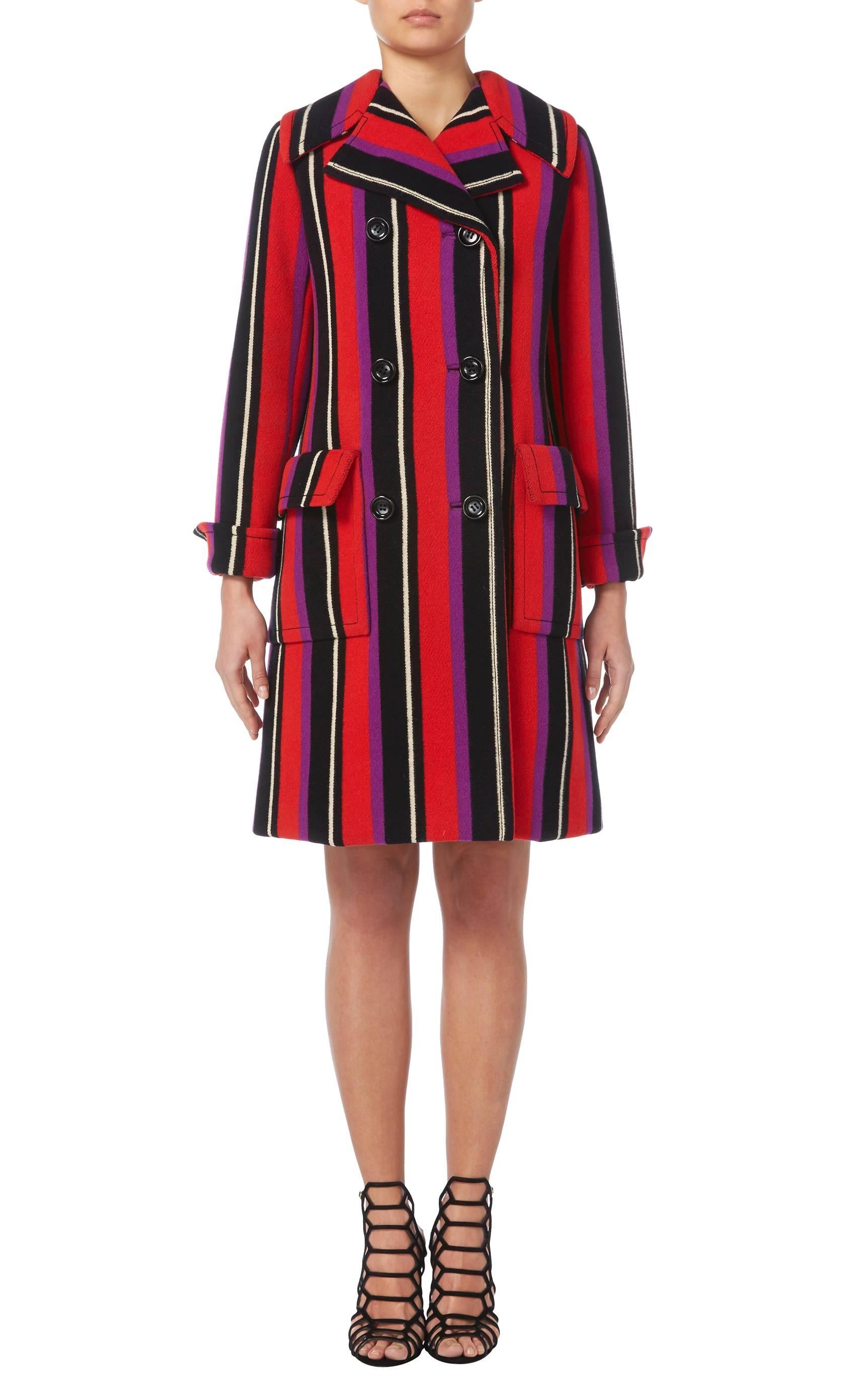 This haute couture Op art striped coat by Marc Bohan for Dior will add a touch fun to a winter wardrobe! Constructed in black, ivory, red and purple wool, the double-breasted coat features overscale pockets on the hips and a half belt to the rear.