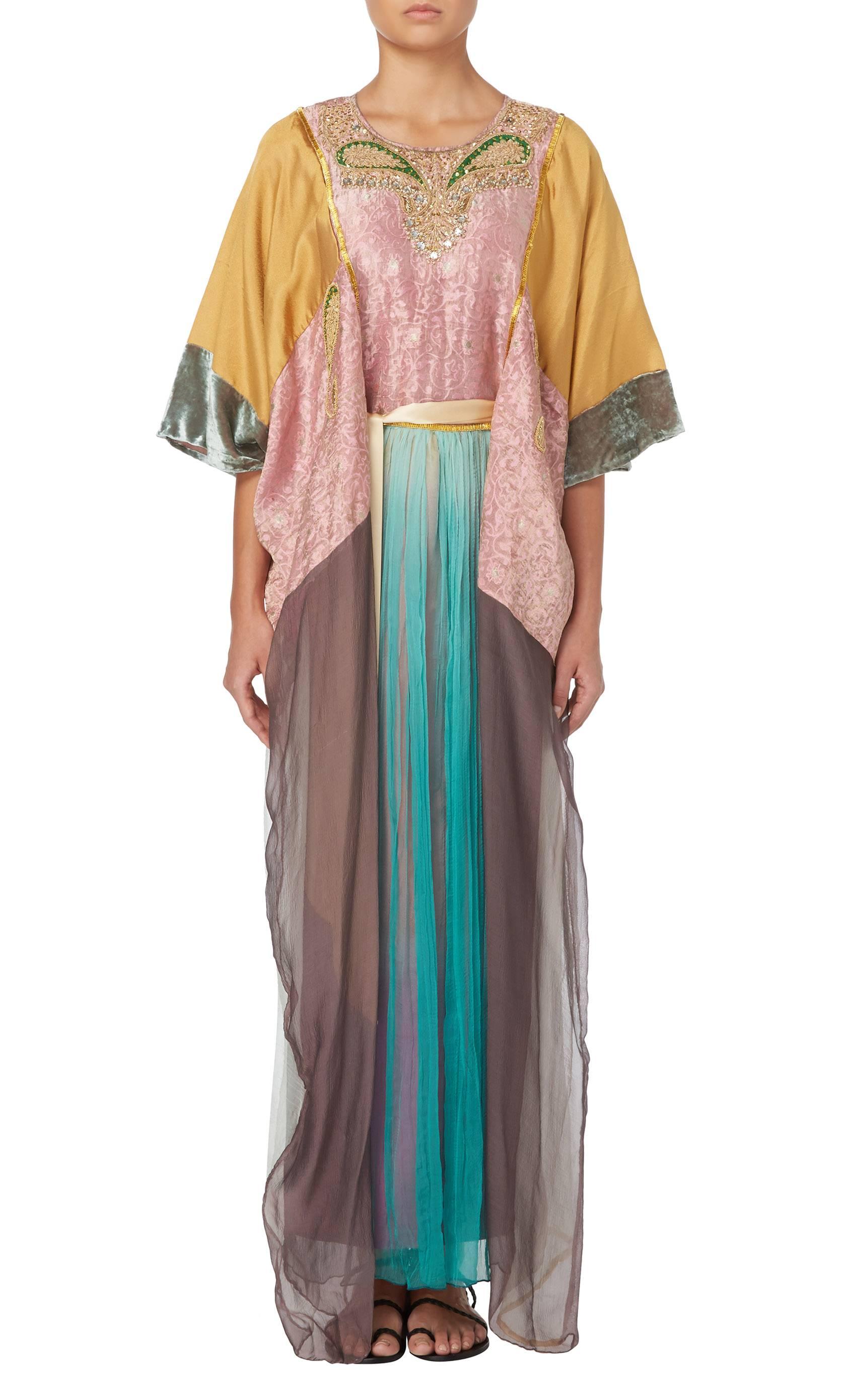 An amazing alternative to a traditional evening gown, this Thea Porter couture kaftan is the height of bohemian luxury. Constructed in a patchwork of silk brocade, velvet and chiffon, the kaftan is embellished at the neckline with gold beads,