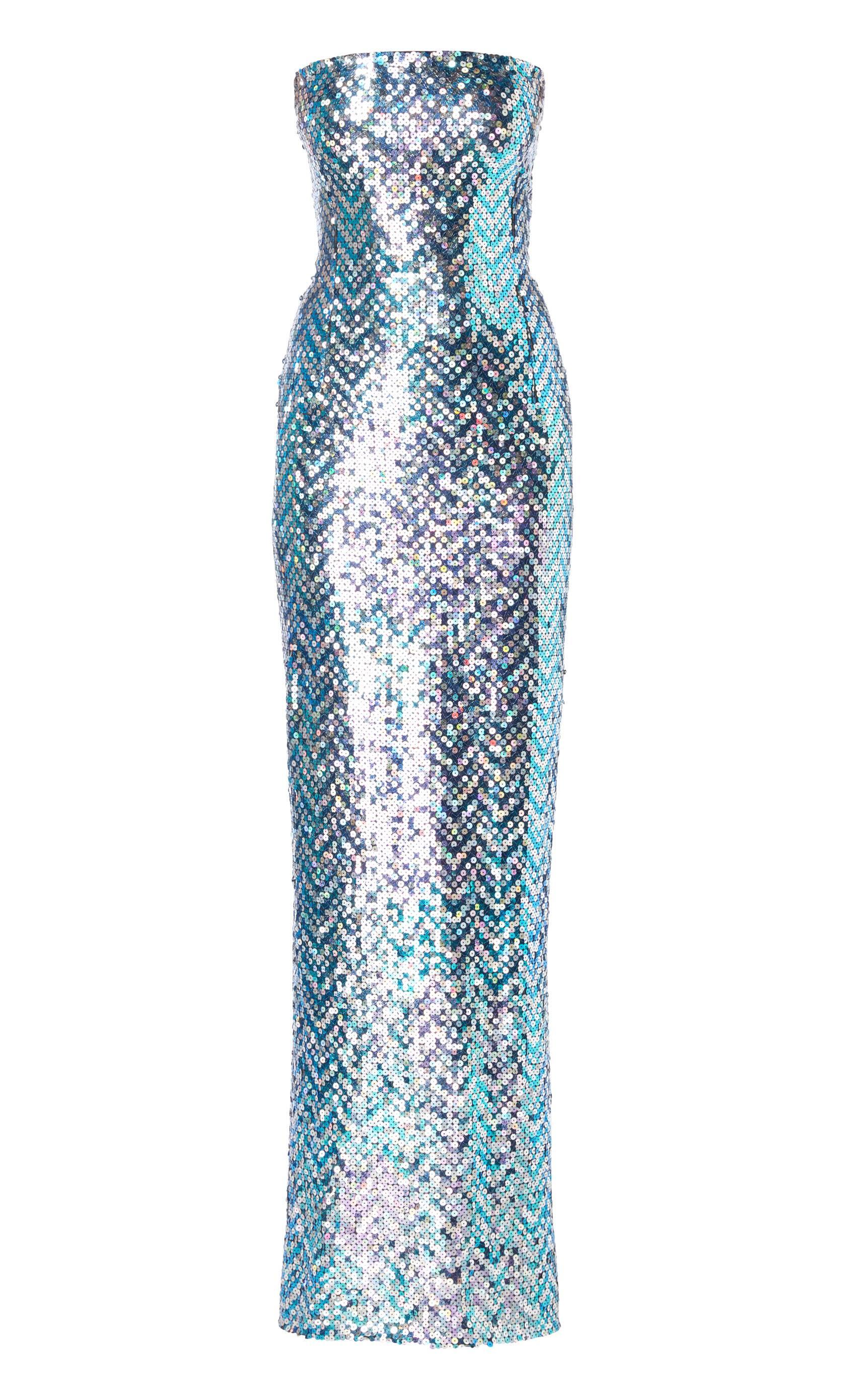 An incredible piece of haute couture, this Pierre Cardin dress is sure to make a statement on the red carpet!  The figure-hugging, strapless dress is entirely covered in iridescent amethyst, blue and silver sequins, and is accompanied by a dramatic