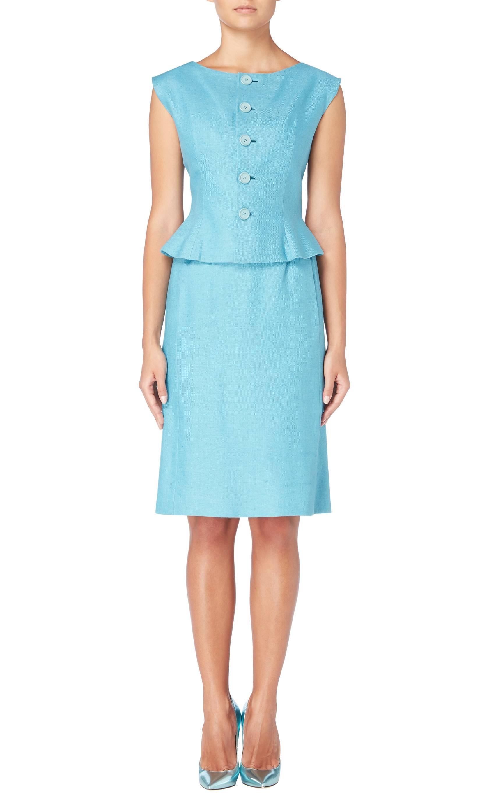 A fantastic piece of summer tailoring, this Norell skirt suit will add a pop of colour to a work wear wardrobe. Constructed in sky blue linen and comprising of a sleeveless top and knee length skirt, the top features buttons to the front, flaring