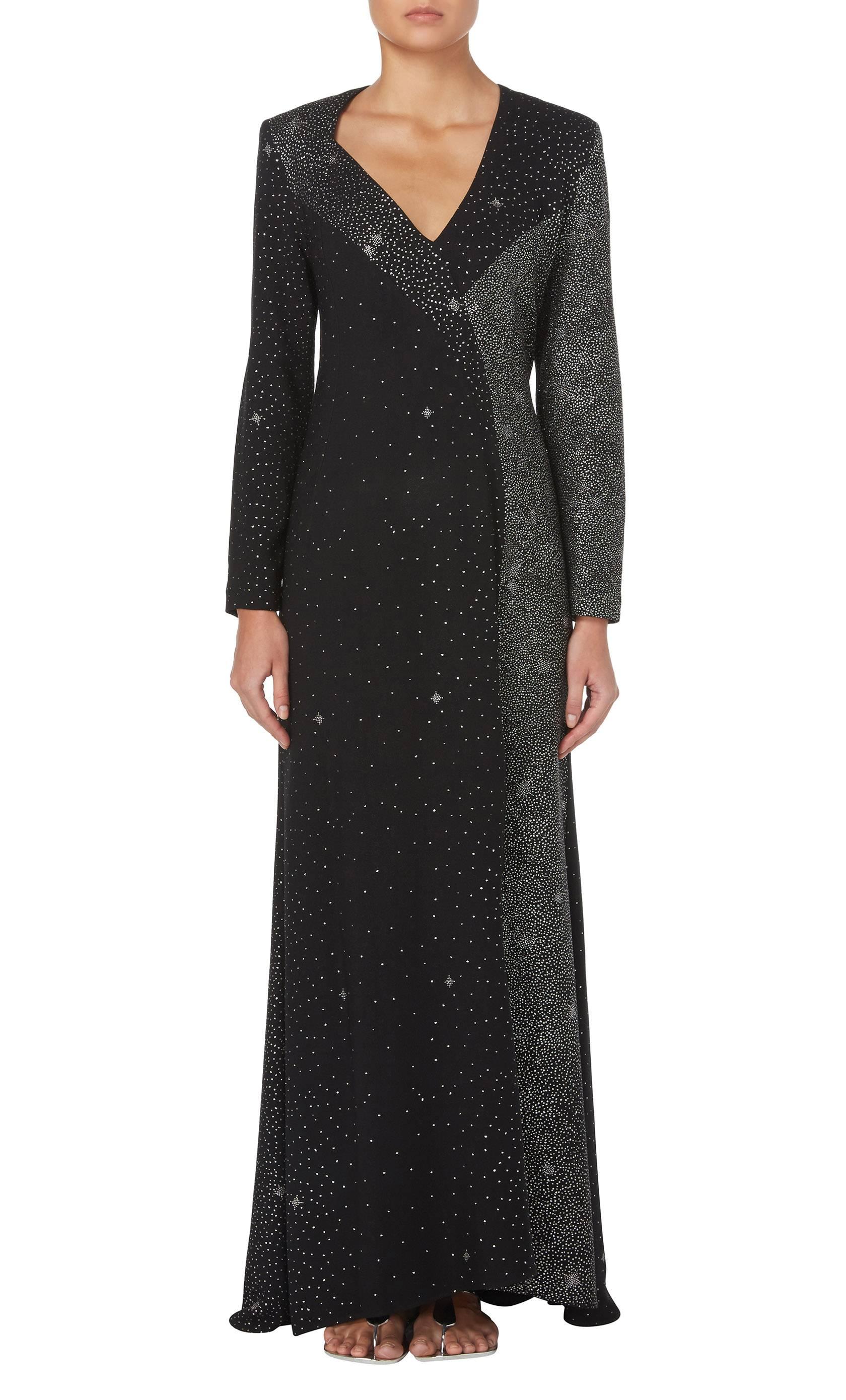 This fabulous evening dress by Christian Lacroix is fantastic option for a black tie event or party. The dress is constructed in black crepe with silver glitter embellishment, creating the effect of constellations in the night sky. Featuring a deep