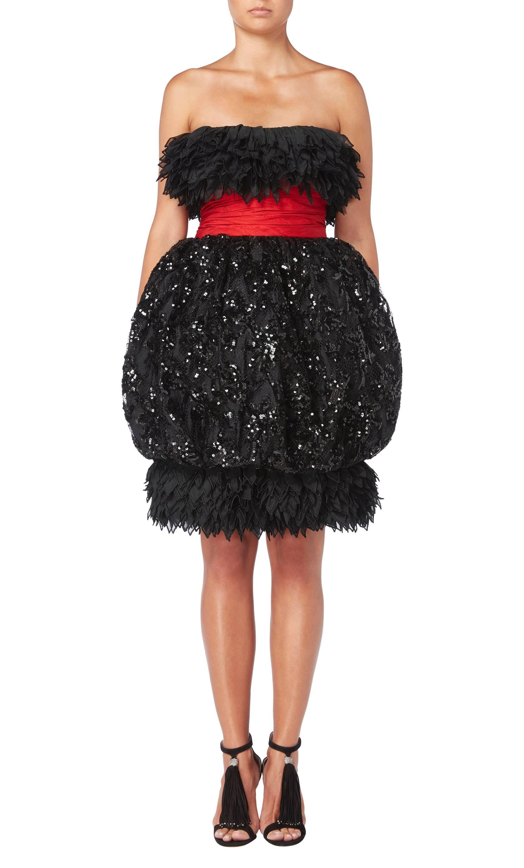 A fabulous example of Christian Lacroix’s designs while head designer at Jean Patou, this haute couture cocktail dress will be sure to make a statement. Constructed in black lace and embellished with thousands of black sequins, the strapless dress