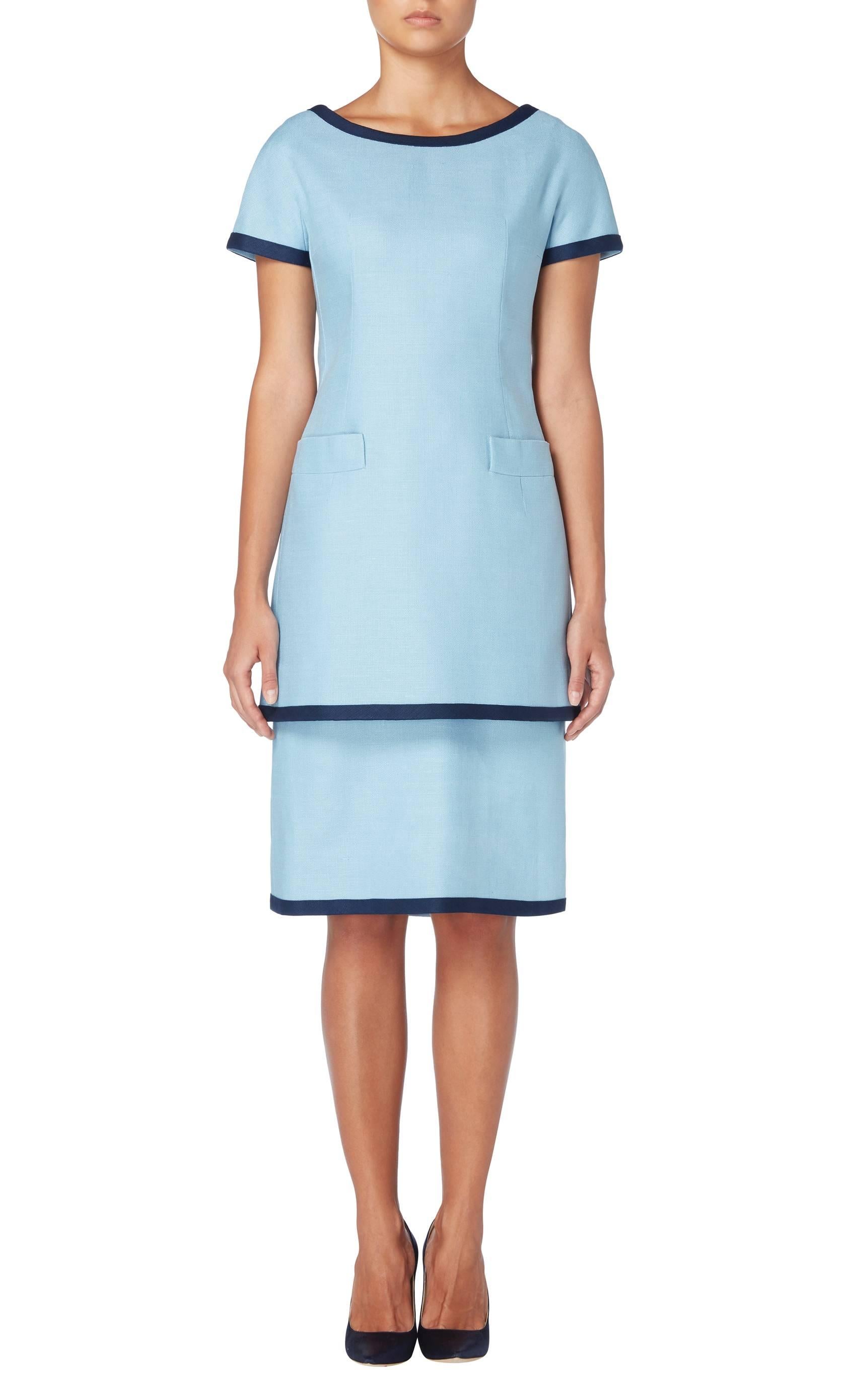 Ideal for the office or daytime events, this Dior two-piece dress will make a great addition to a summer wardrobe. Comprising of a sleeveless silk and linen under dress, and a short sleeved over dress, both pieces feature a contrasting navy blue