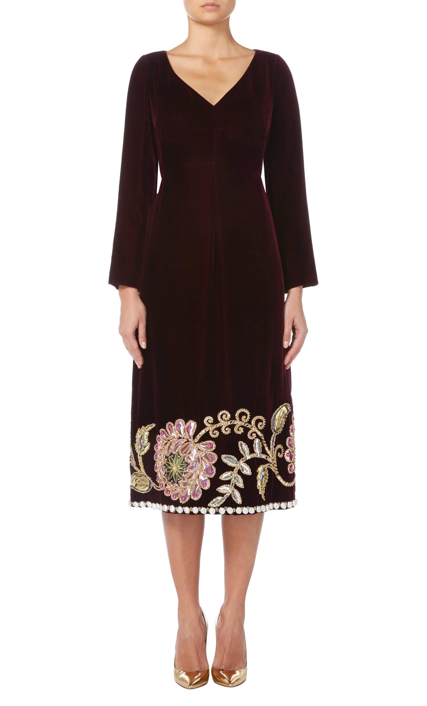 This dress is an amazing example of Marc Bohan for Dior from the Autumn Winter 1969 collection. Constructed in plush purple velvet, the dress features a v-neckline and long sleeves, while the hem is heavily embellished with metallic applique and