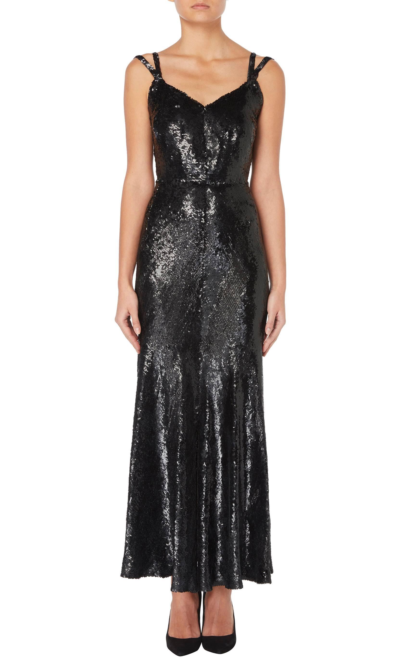 A rare and early example of Gabrielle ‘Coco’ Chanel at the height of the Art Deco period, this haute couture gown is constructed in black silk and fully embroidered with shimmering black sequins. Featuring a four-panel bodice and a deeply cut back,