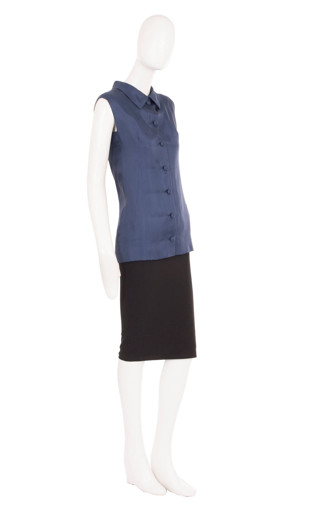 This haute couture sleeveless shirt by Balenciaga for his Eisa label is a fantastic wardrobe staple, whether paired with a pencil skirt to the office or tailored trousers for everyday. Constructed in deep navy silk the shirt features a double lapel