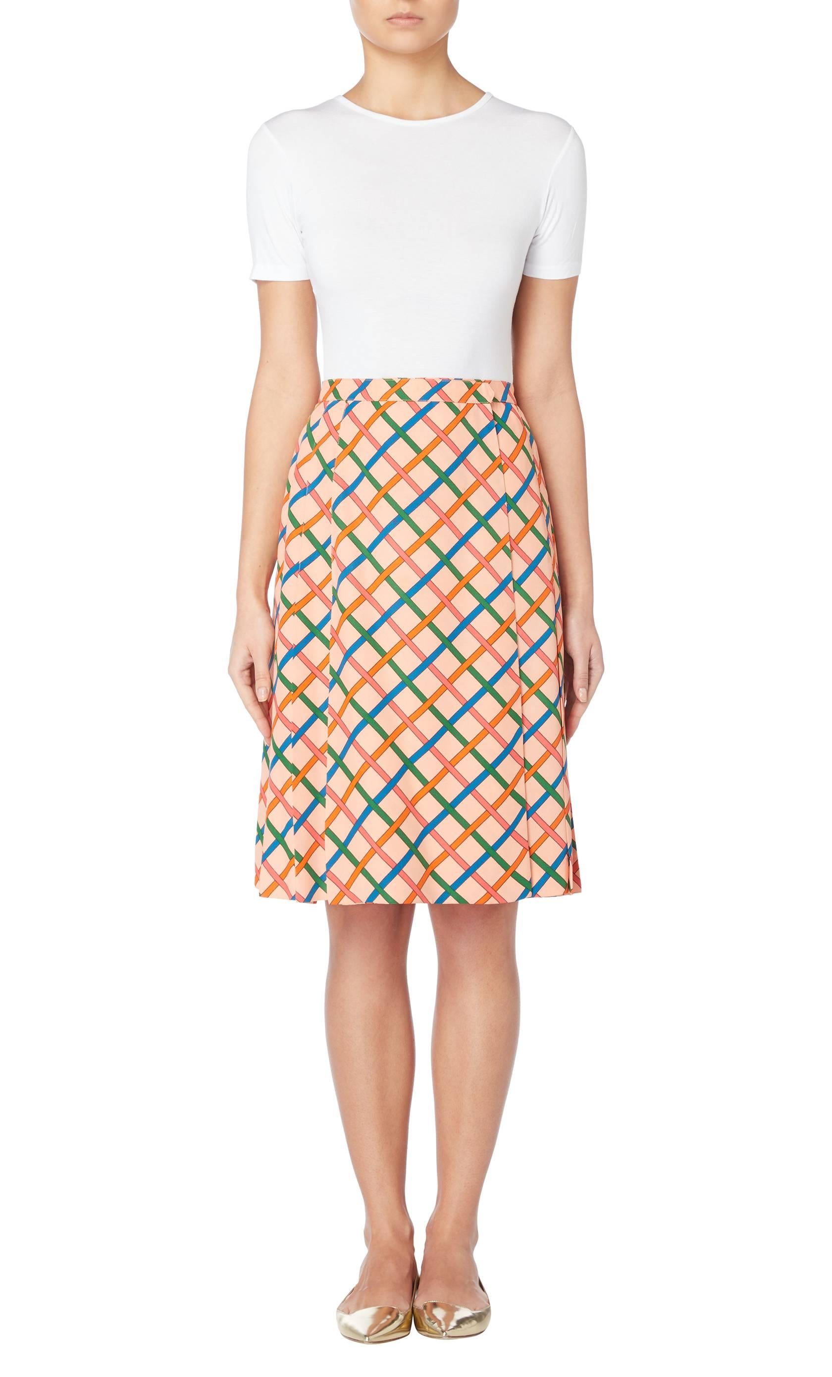 Constructed in pale pink knife pleated silk, this Yves Saint Laurent wrap skirt features a bold print in shades of blue, green and orange.

Constructed in pale pink silk with a blue, green and orange print
Featuring knife pleats to the back and