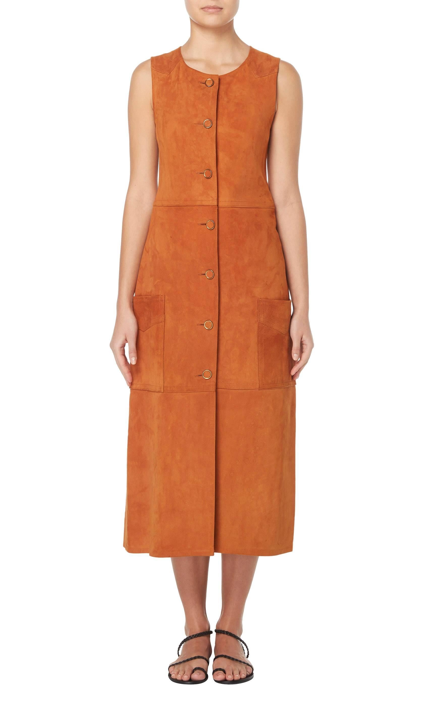 A fun piece for a festival, this two-piece is constructed in soft brown suede with a worn-in feel. The long sleeveless jacket fastens to the front with buttons and features pockets to the front and a split to the rear, while the culottes lace-up on