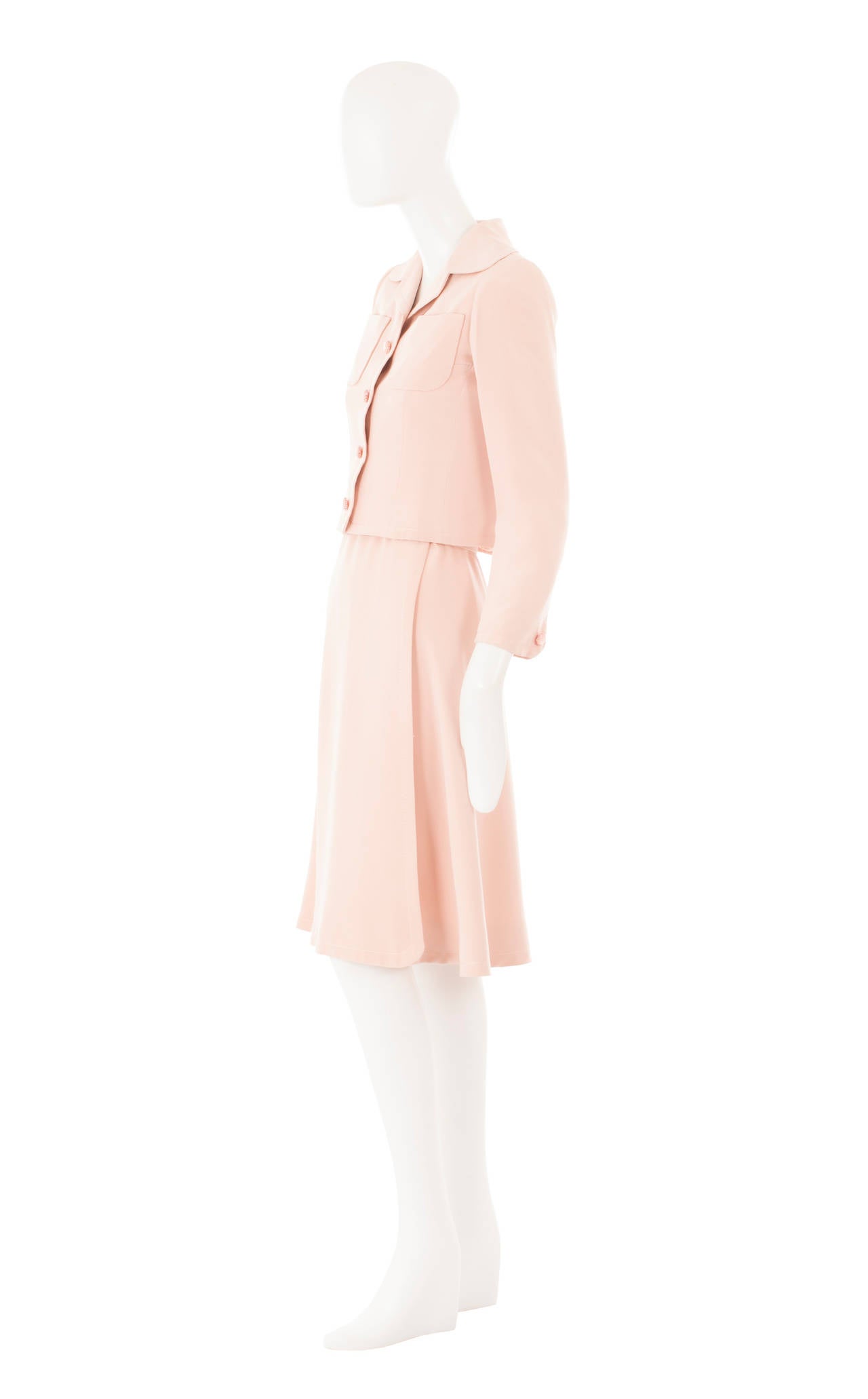 A gorgeous piece of haute couture, this Guy Laroche dress suit constructed in pale pink silk, is perfect for daytime events. The sleeveless dress has an extremely flattering cut, skimming the body and flaring into a softly pleated skirt. The jacket