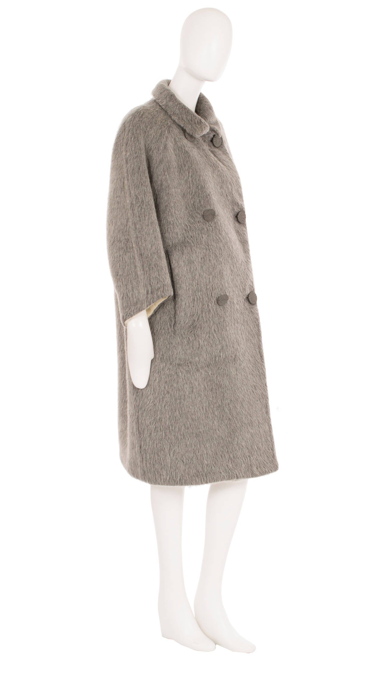 A fantastic example of one of Balenciaga’s most iconic silhouettes, this cocoon coat was designed for his Eisa label. Constructed in double-faced wool, the coat has an amazing texture and contrasts between the ivory inside and grey on the outside.