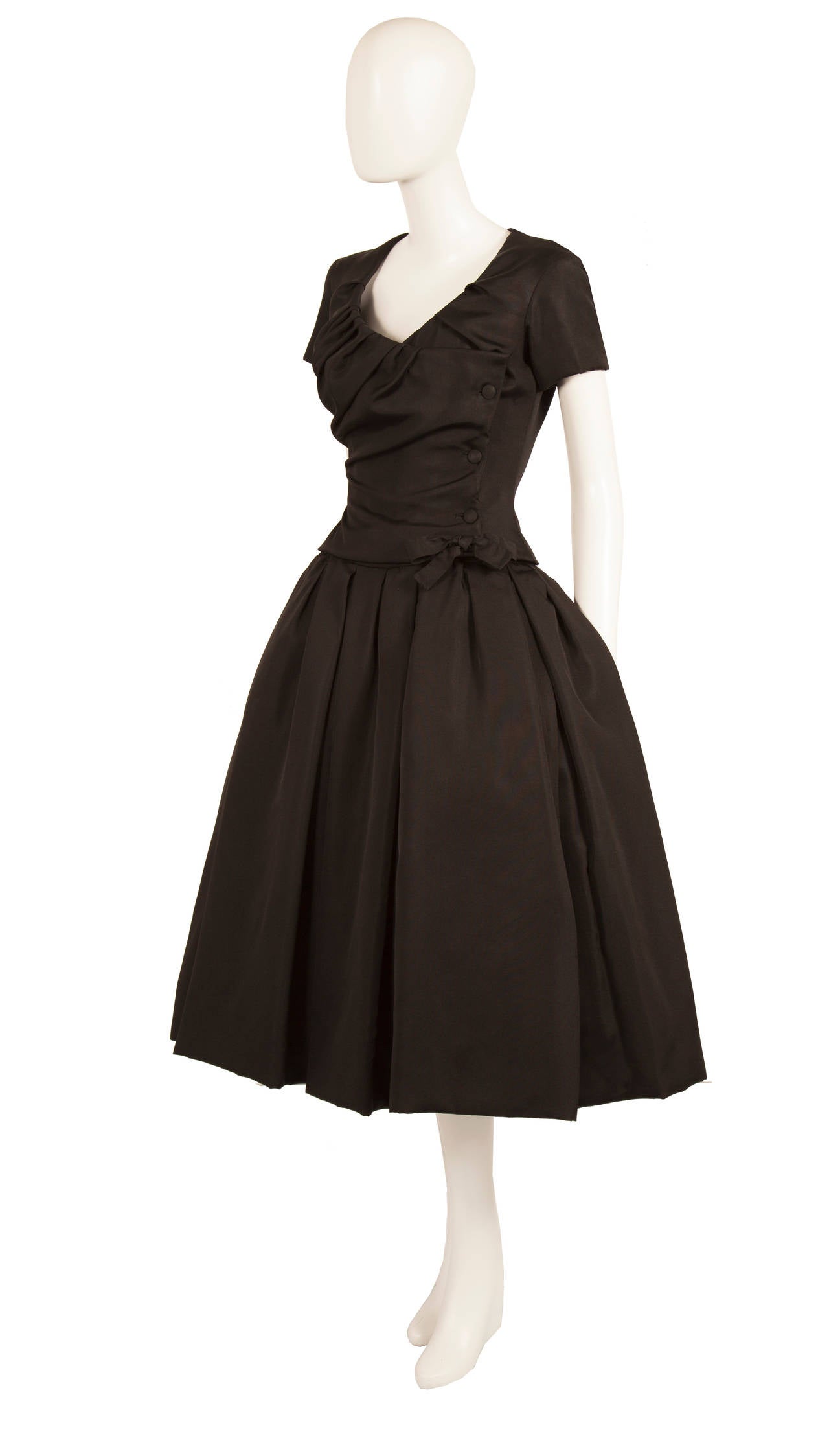 An exceptionally fine and rare haute couture dress designed by Christian Dior from the Autumn/Winter 1954 H-Line collection. The H-Line was a departure from the Dior ‘New Look’ of previous years, with elongated bodices and dropped waistlines, and is