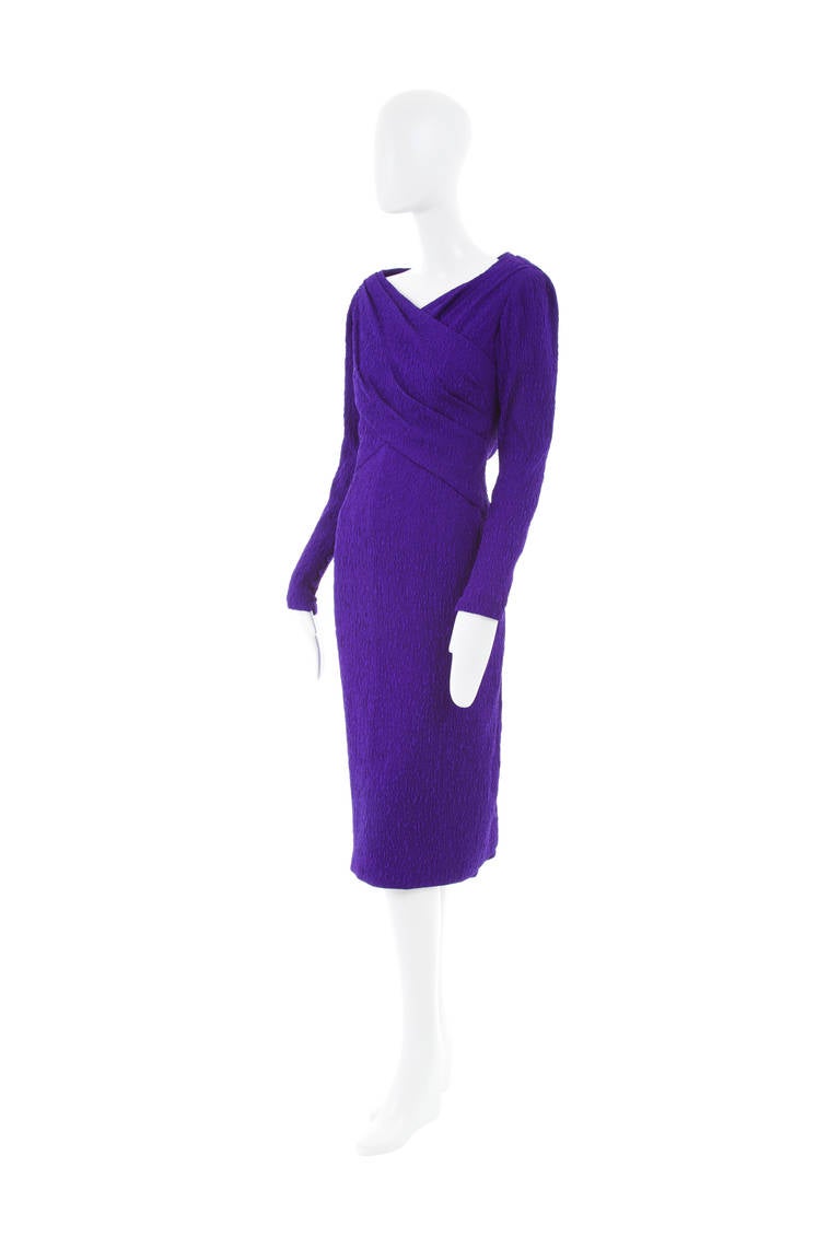 An exceptional piece of haute couture composed of cloque silk in cardinal purple, the dress is superbly constructed with a boned internal corset and multiple zips and fasteners creating the sinuous, perfectly tailored polished look associated with
