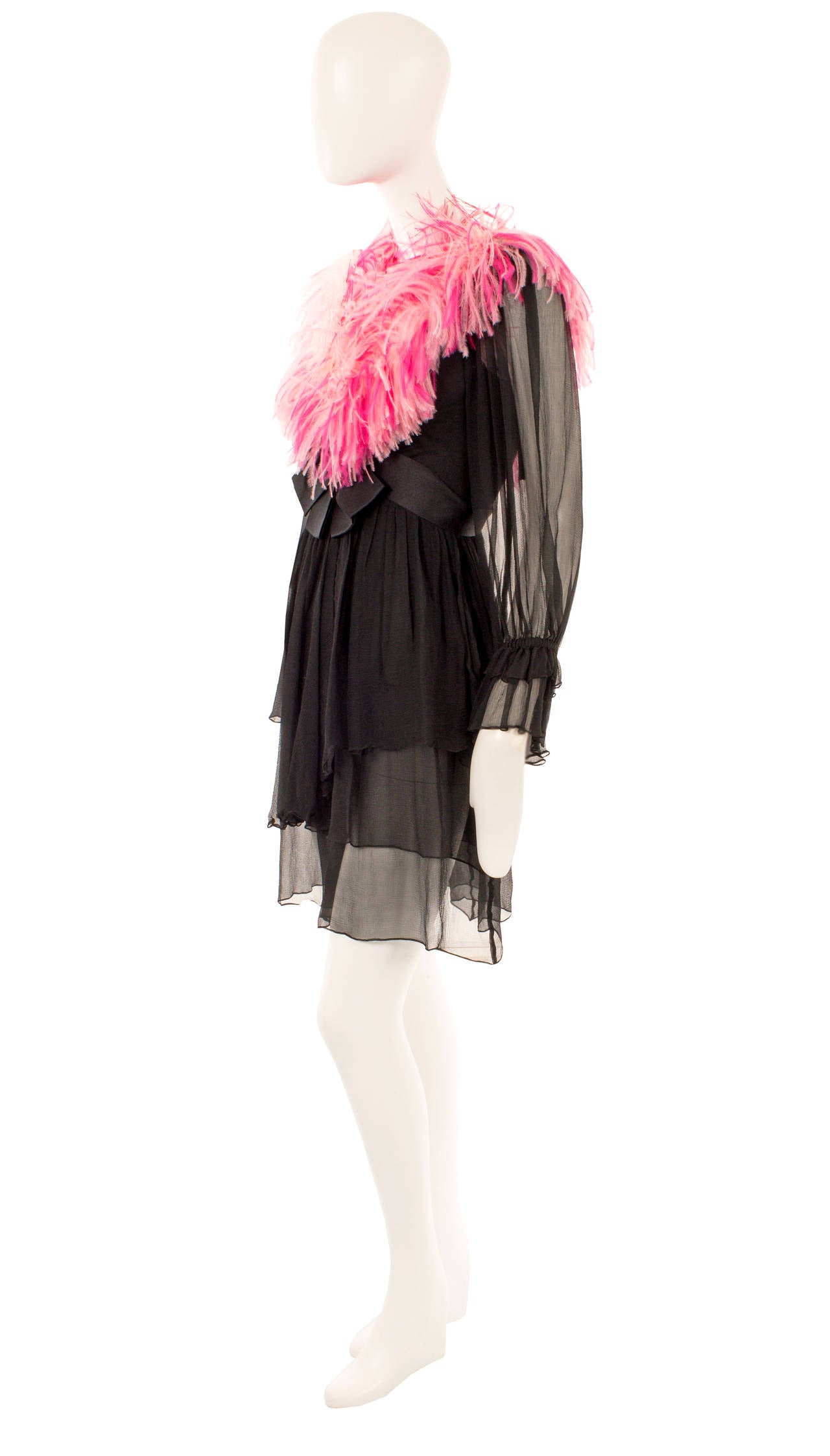 A fun take on the classic LBD, this Yves Saint Laurent babydoll dress is the perfect choice for an eye-catching party look. Constructed in black silk chiffon, the neckline is trimmed in pink marabou feathers, while a black satin bow sits under the