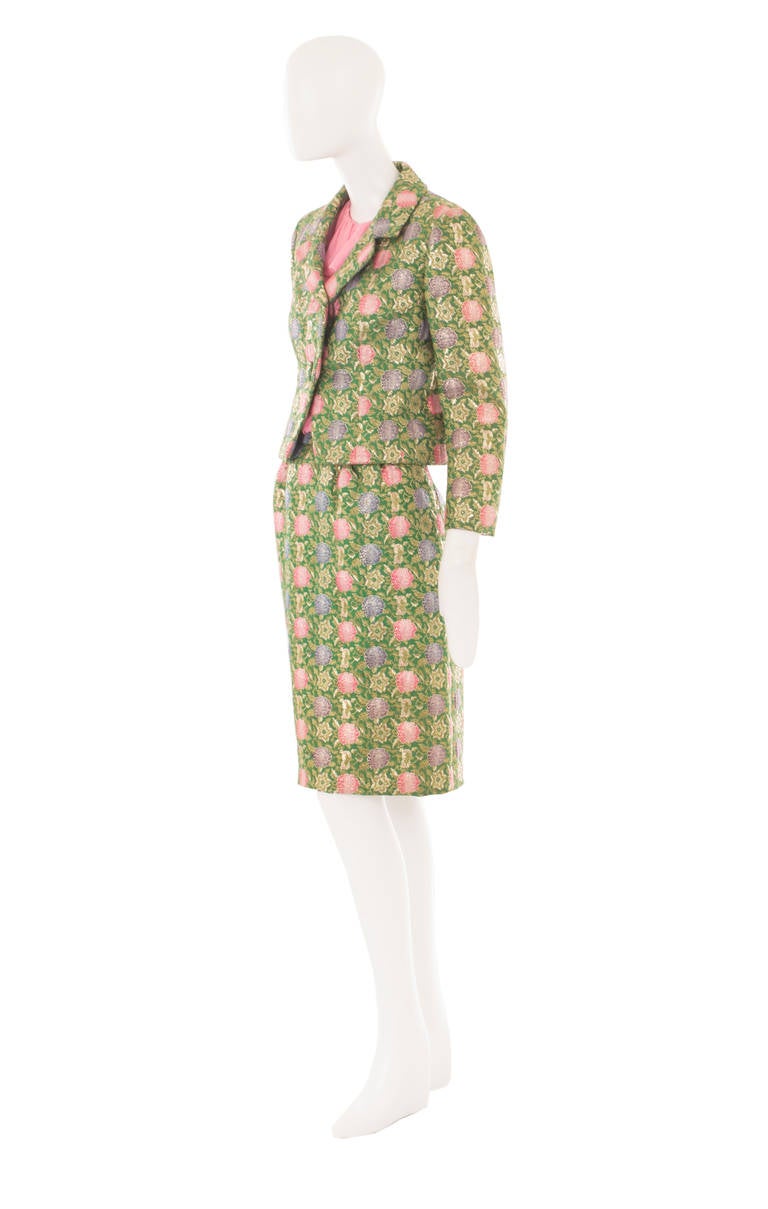 This Christian Dior skirt suit, comprising of a jacket, skirt and top, is a great option for daytime events. The top is constructed in pink silk chiffon, with a gathered detail on the bust and waist, while the jacket and skirt are made from a