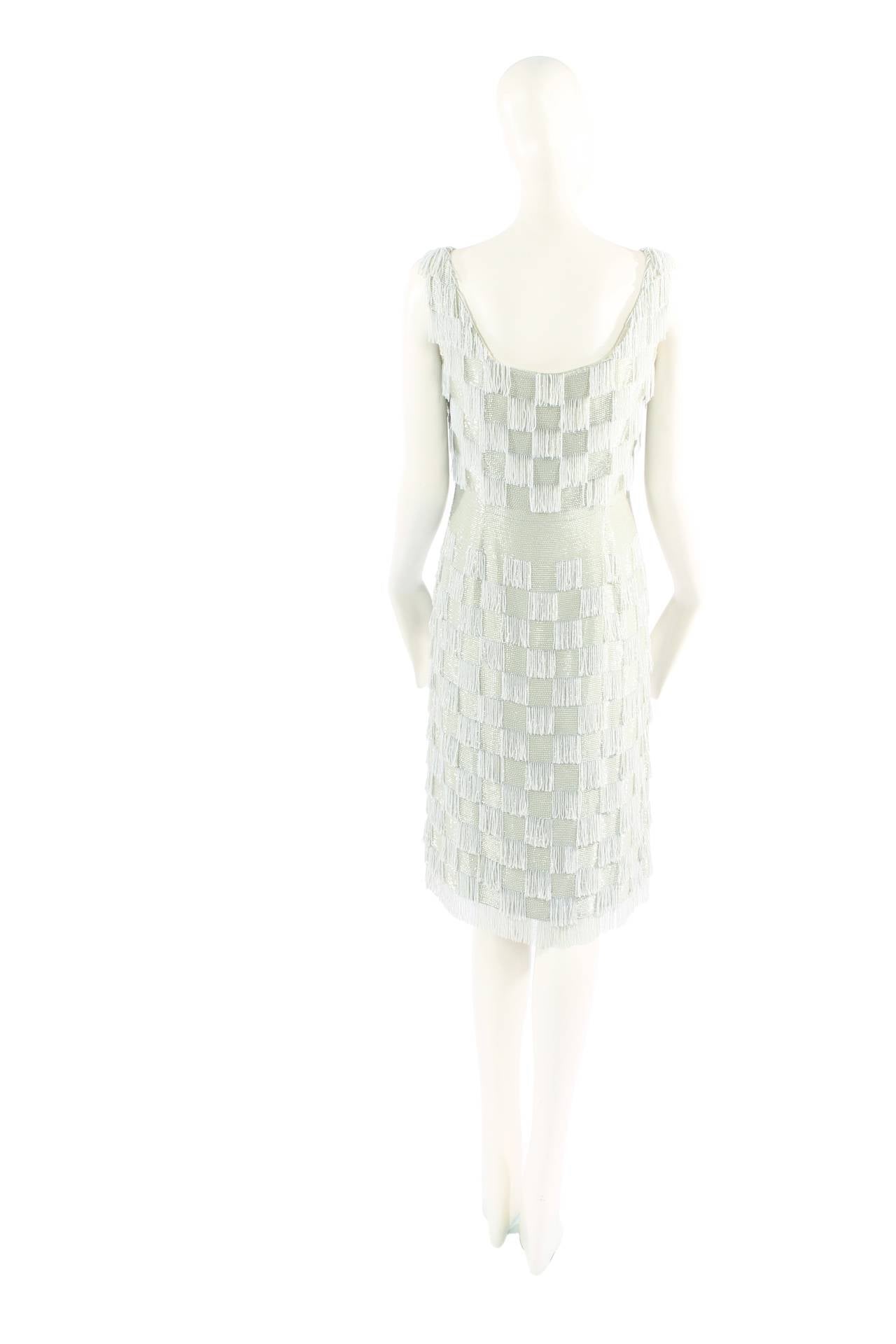 A wonderful haute couture example by one of the greatest couturiers of the 20th century. Crafted in fine celadon silk, the dress is entirely hand-beaded in squares of bugle beads and strung round beads in the same celadon shade, creating a