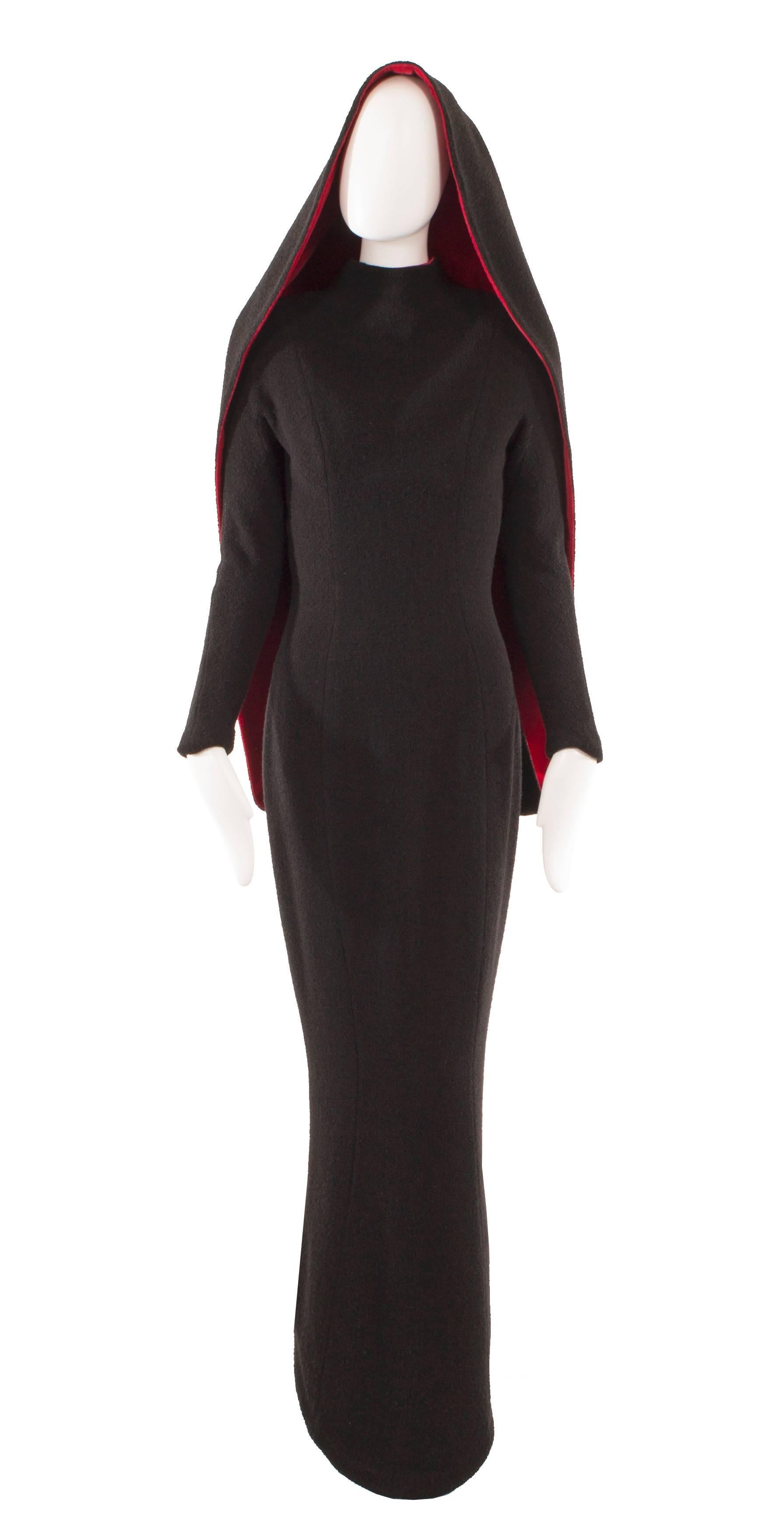 A show-stopping choice for a red carpet event, this Thierry Mugler evening gown will be sure to make a statement! Constructed in black boucle wool, which skims the body, creating a flattering hourglass silhouette. Featuring a high neckline to the