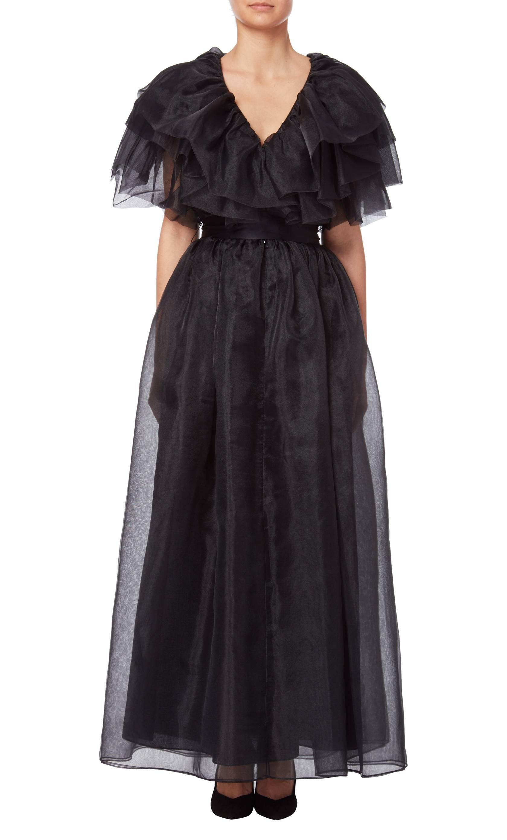 Black organza ruffle evening gown attributed to Halston, circa 1979. The gown has a matching sash and bears the venerable Giorgio of Beverly Hills Boutique label. A similar gown in an alternate colourway is part of the permanent collection at The