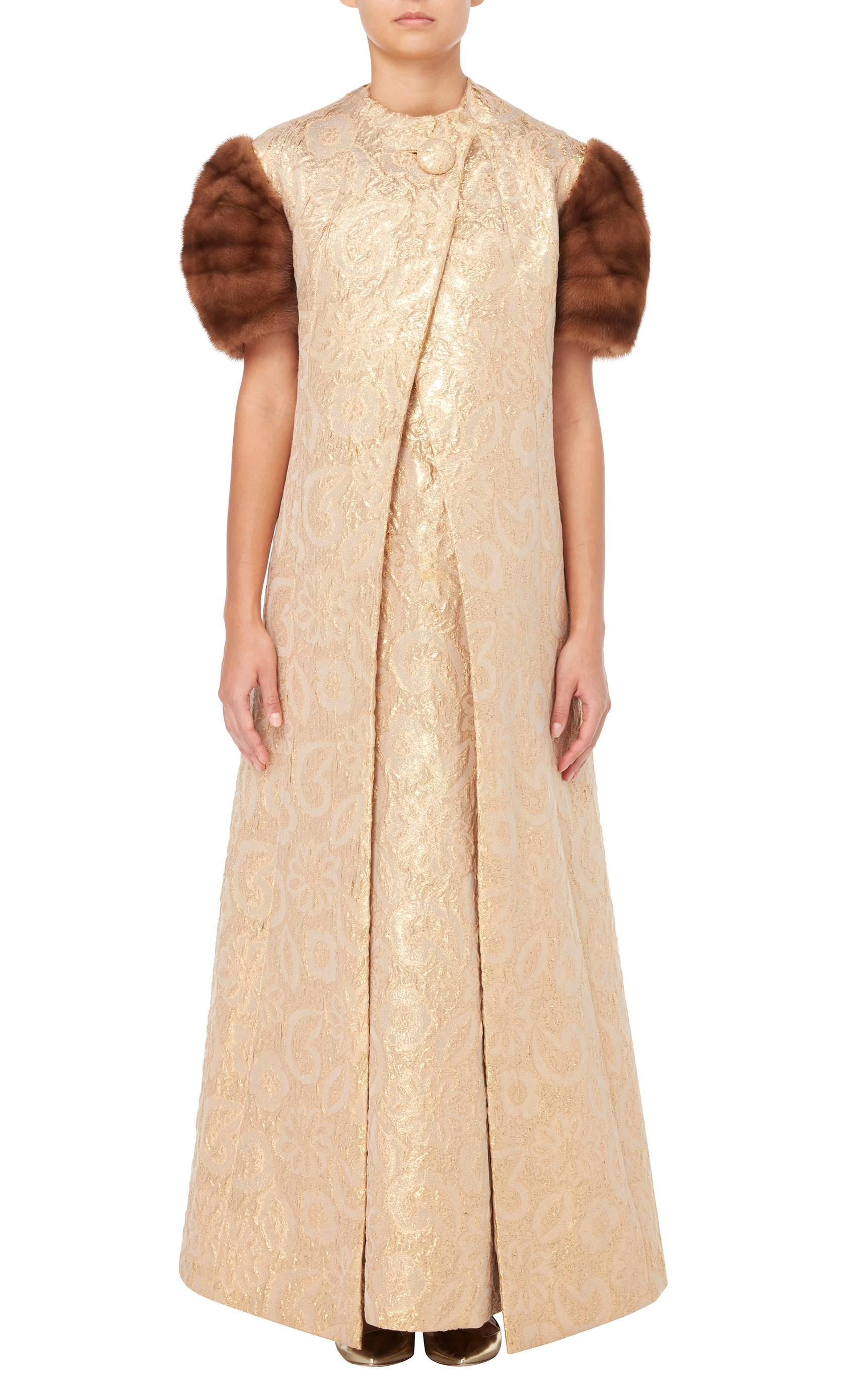 This Pauline Trigere dress and coat will make the perfect option for occasions that call for full on glamour! Made up of a maxi dress and sleeveless coat, the evening ensemble is constructed in shimmering gold Lurex and can be worn together or